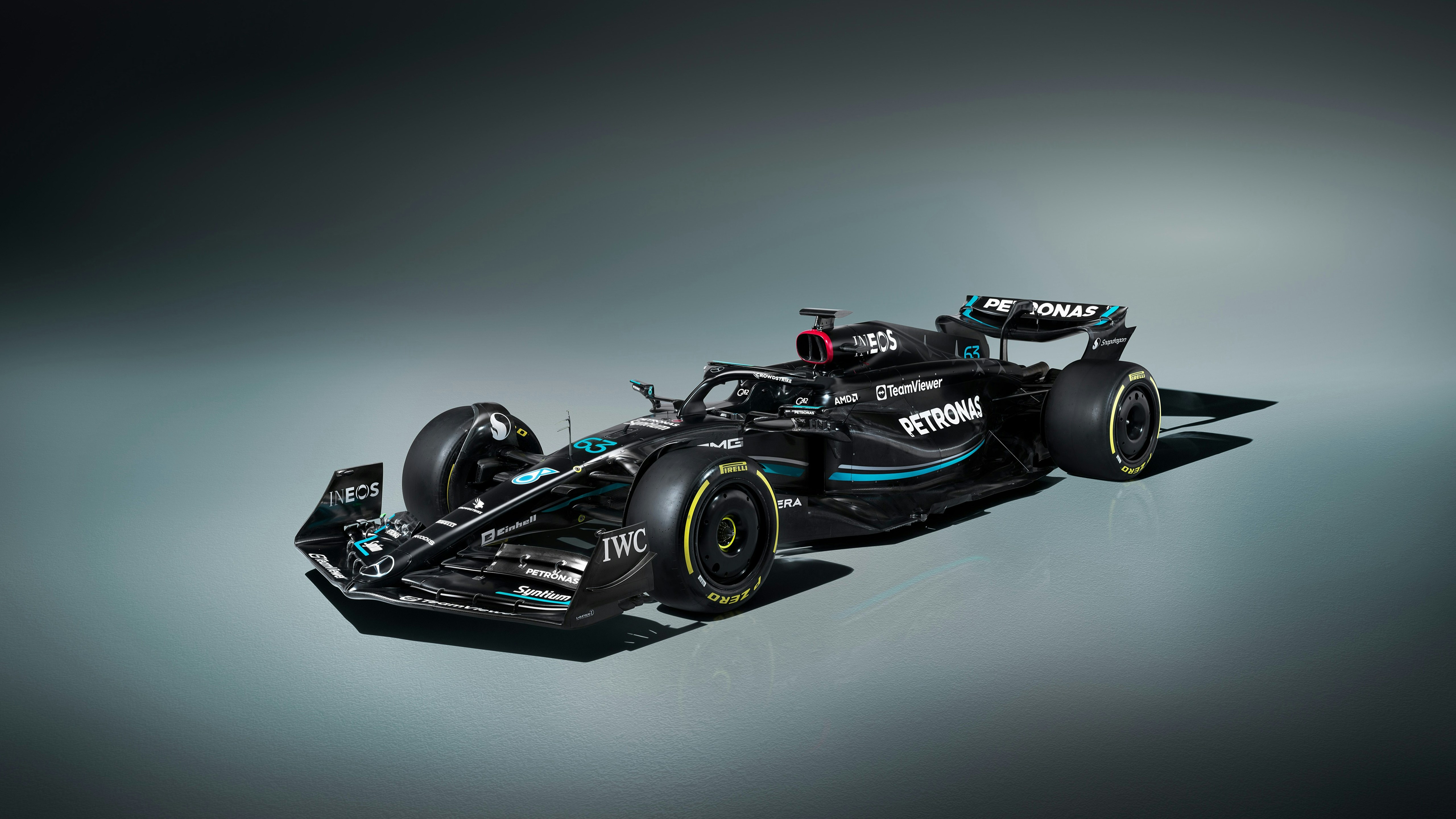 A sleek black formula 1 race car with yellow accents.