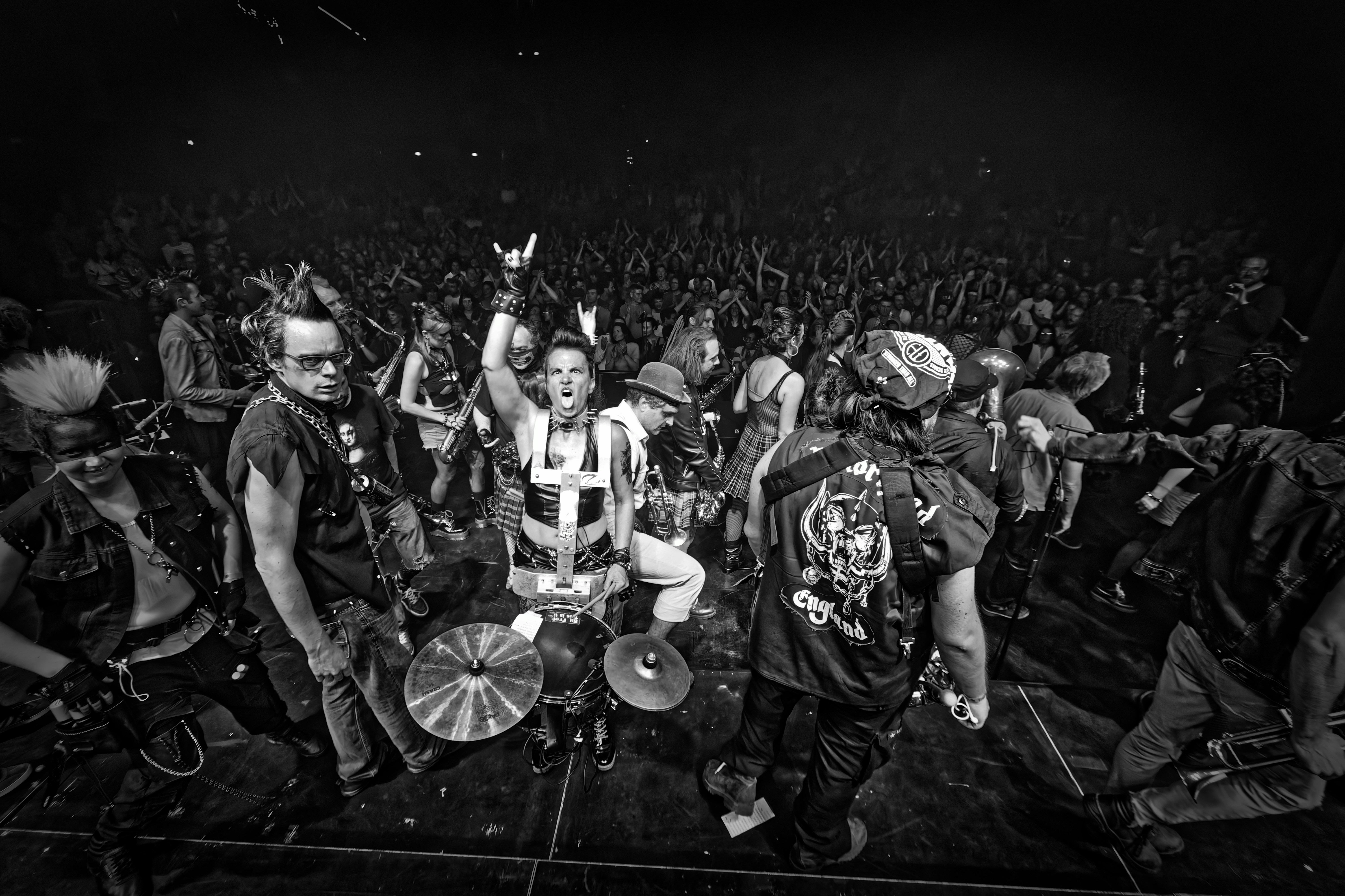 A punk band performs for an enthusiastic crowd