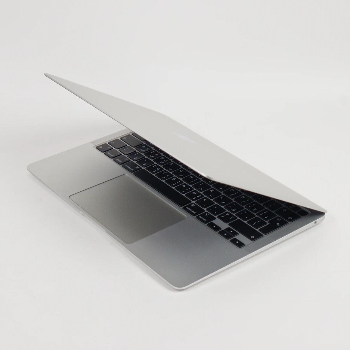 A silver laptop with the screen partially open