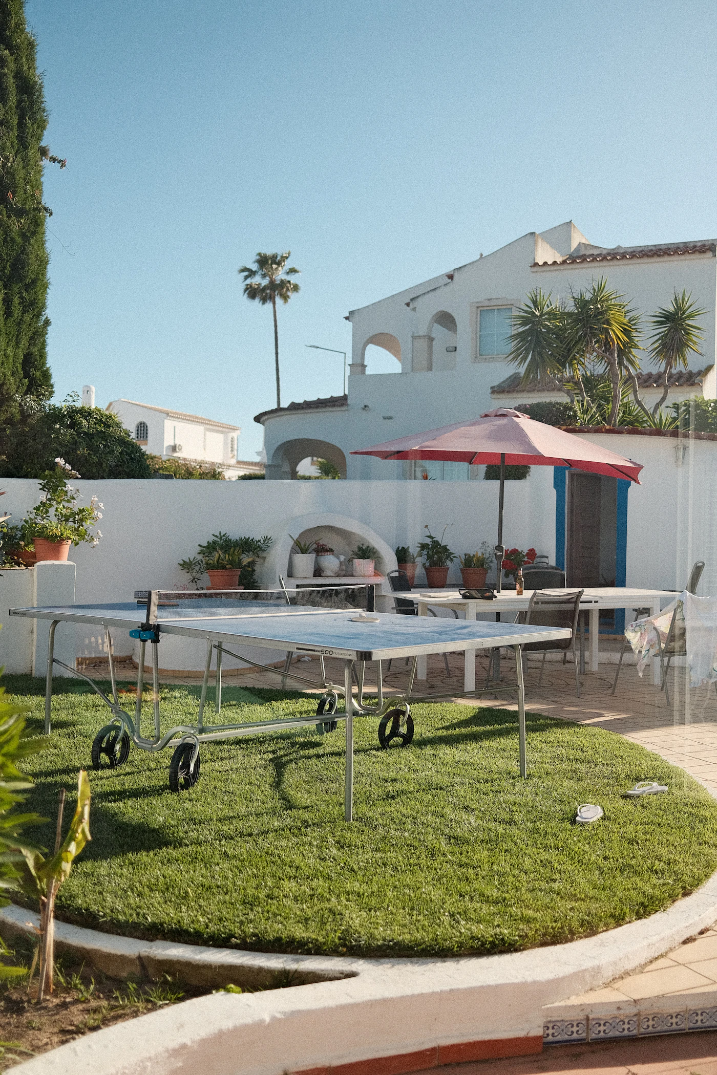 A sunny residential backyard lawn set up for outdoor games