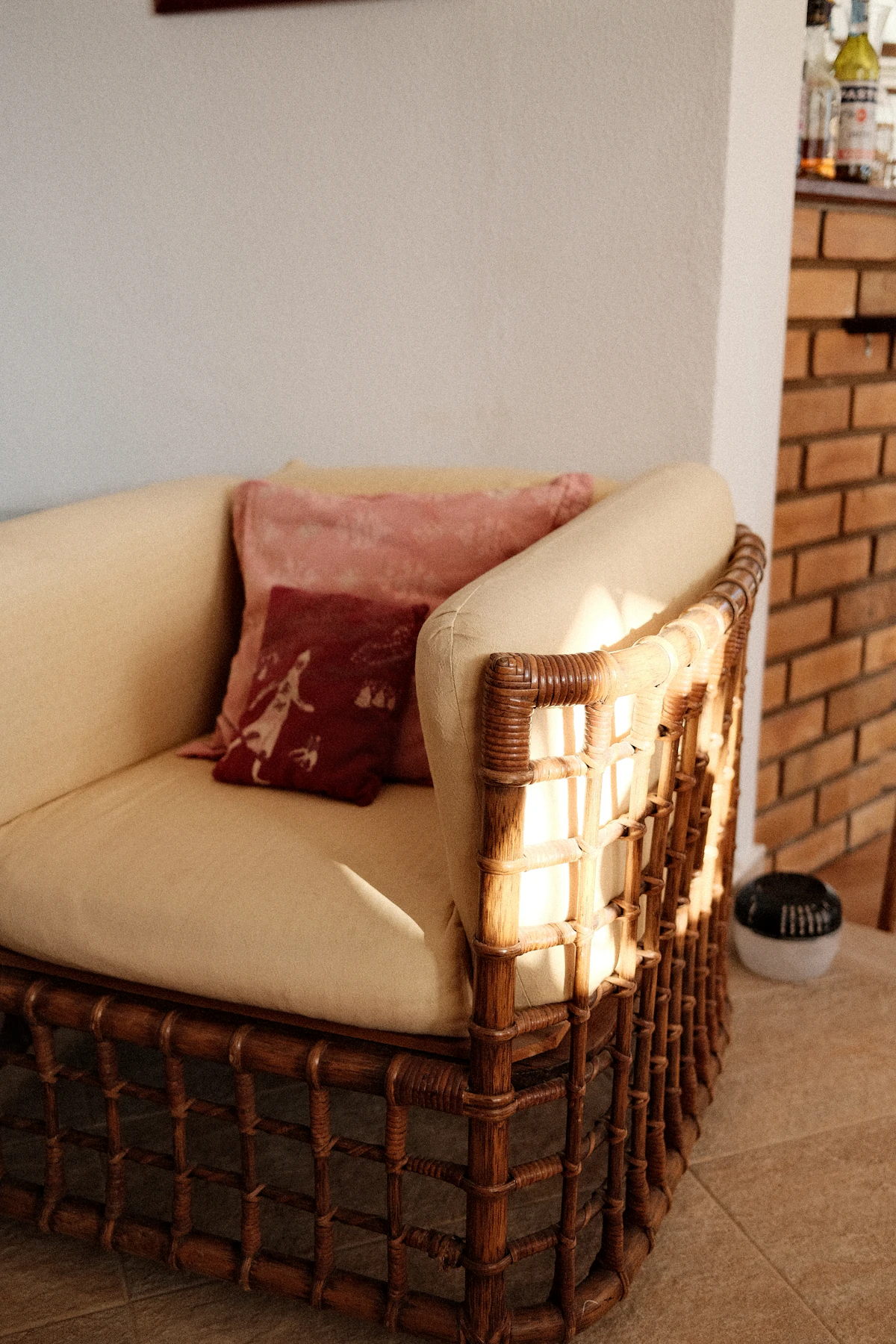 Woven rattan chair with linen cushions