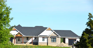 A modern house under construction with a gray roof.