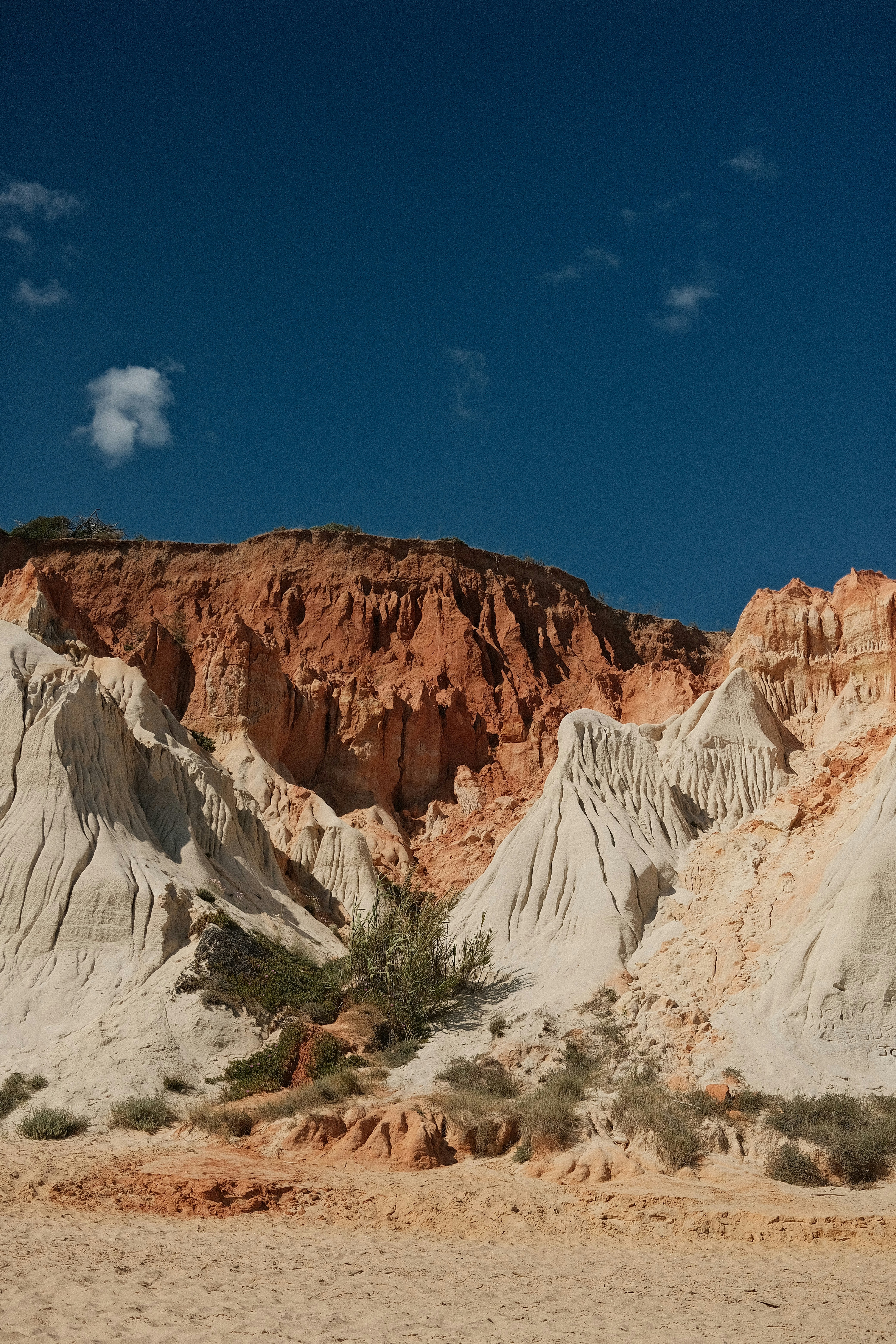 Layered sandstone cliffs under a clear blue sky.