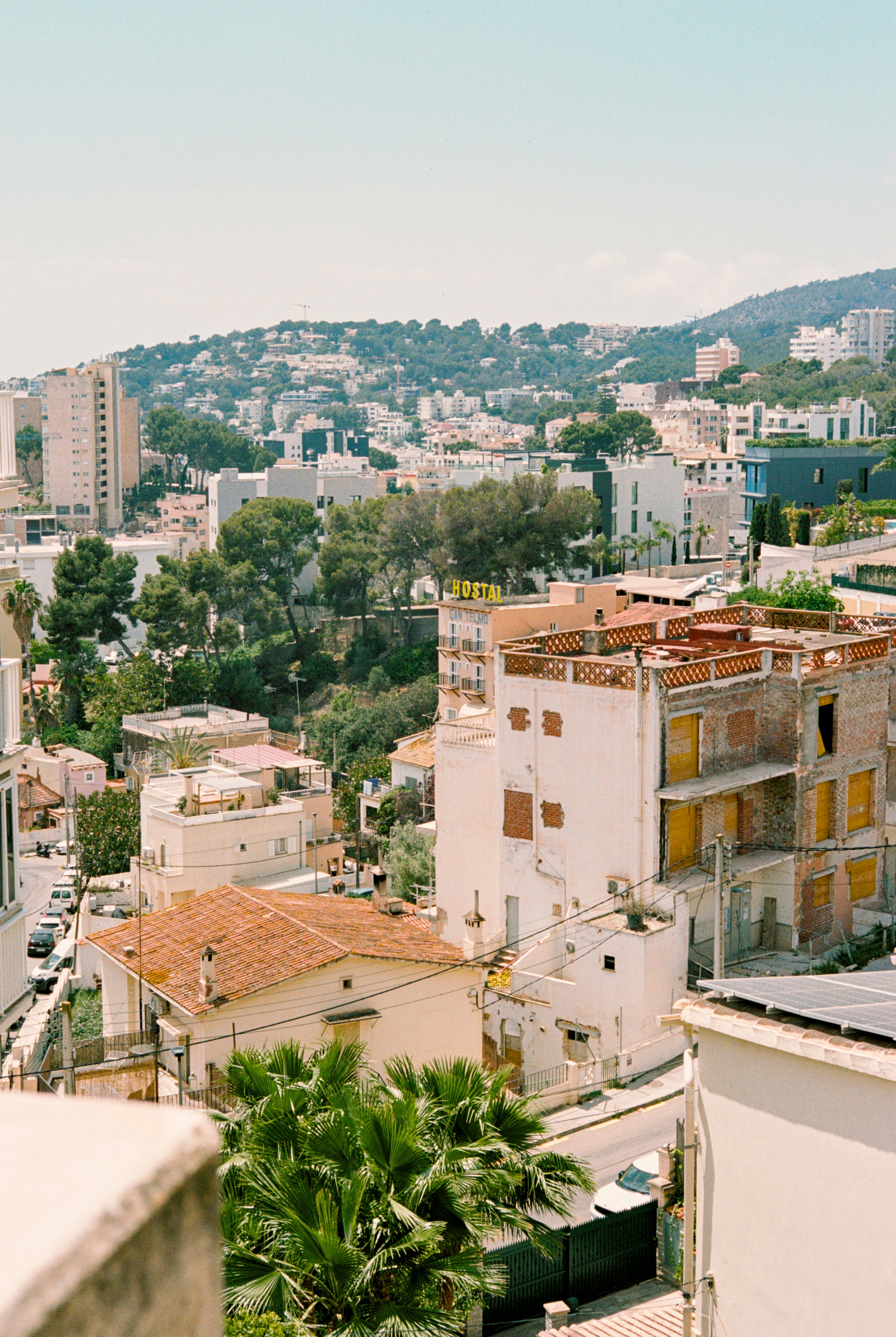 View of a mediterranean town with buildings and trees.