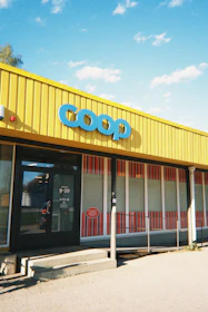 A bright yellow coop grocery store facade