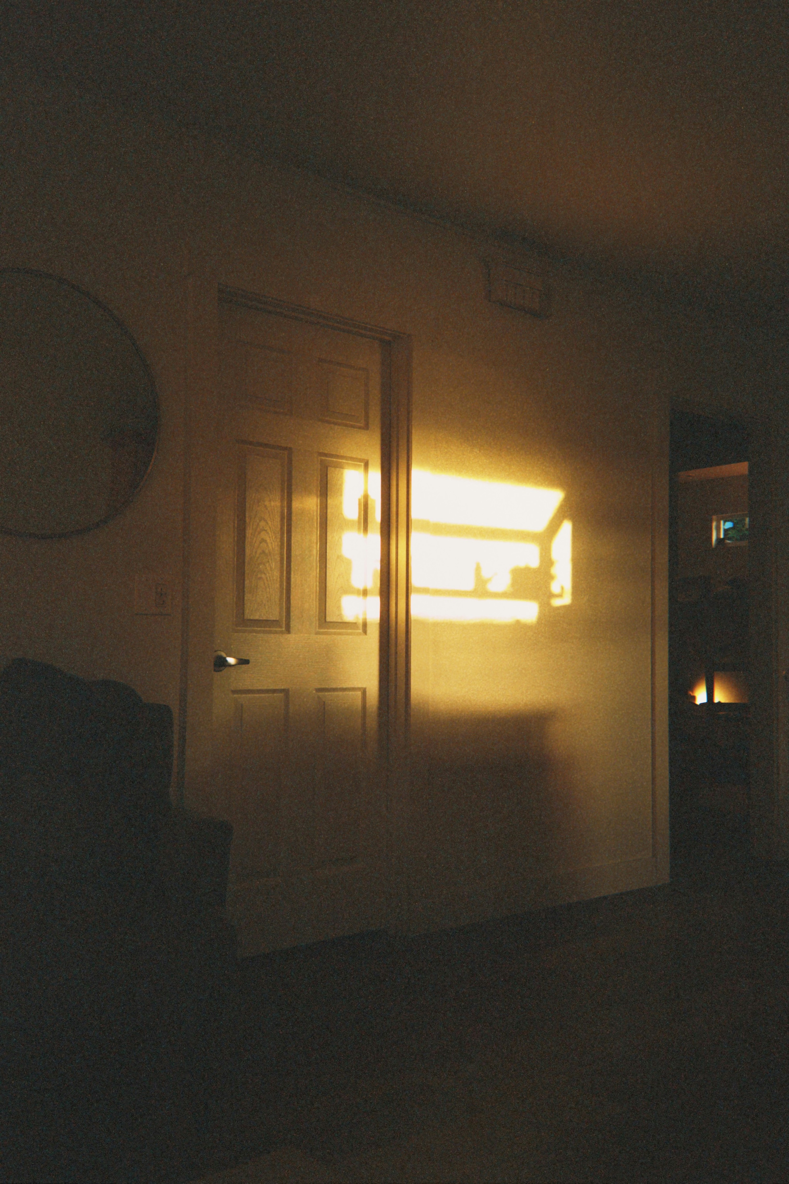 Sunlight streams through a doorway onto a wall.