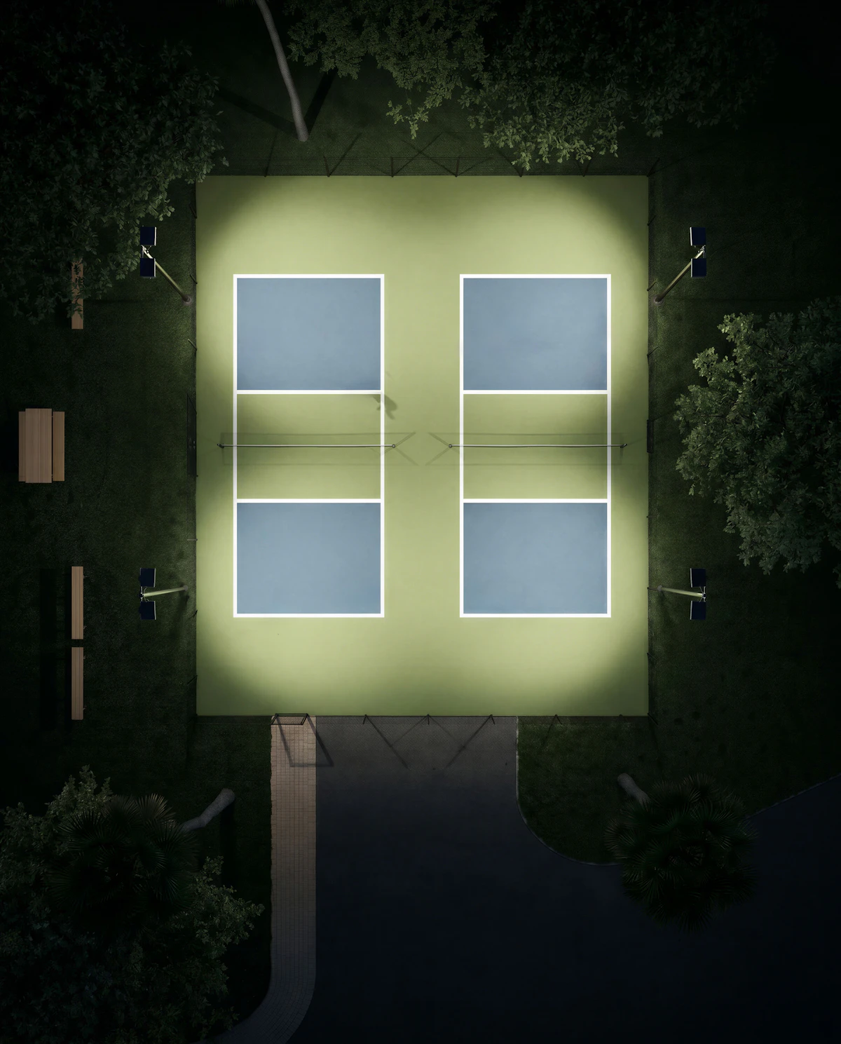Illuminated pickleball courts at night, seen from above