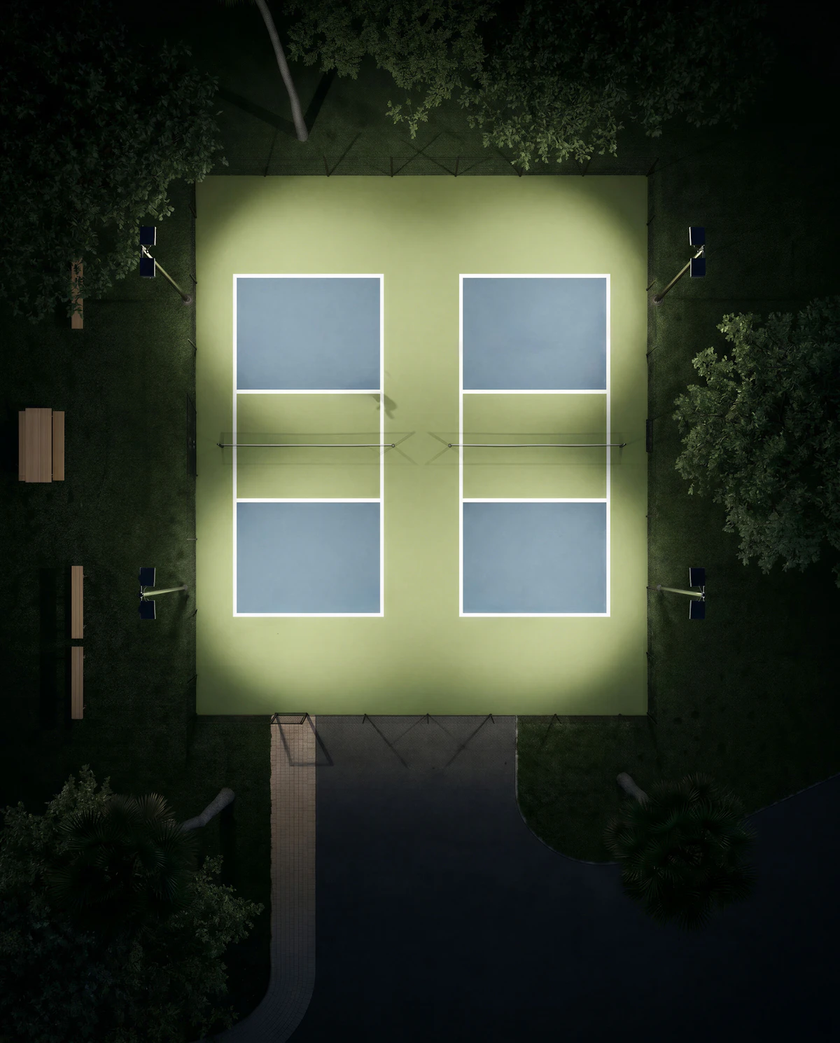 Aerial view of illuminated pickleball courts at a modern sports facility