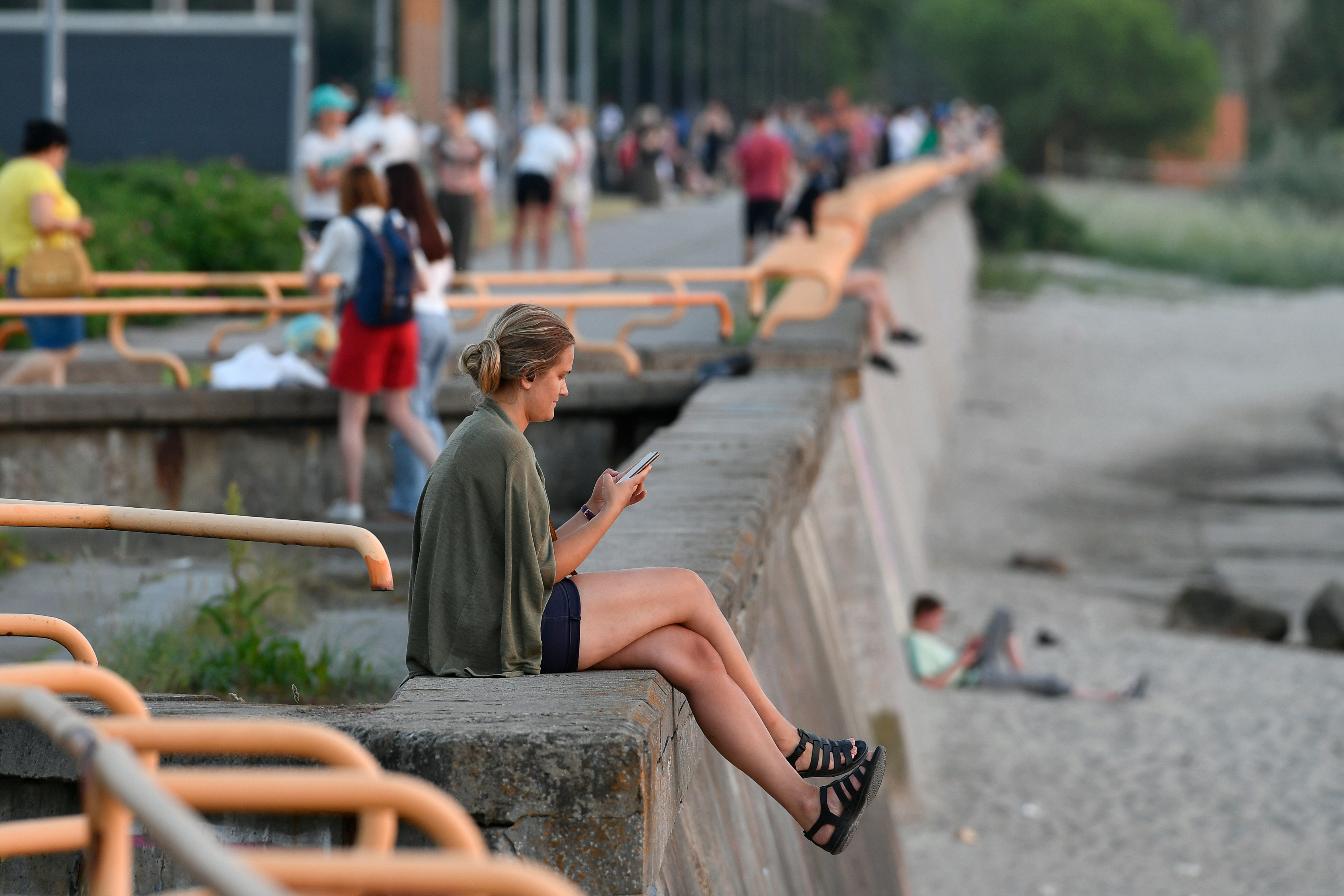 people watching from waterfront railing
