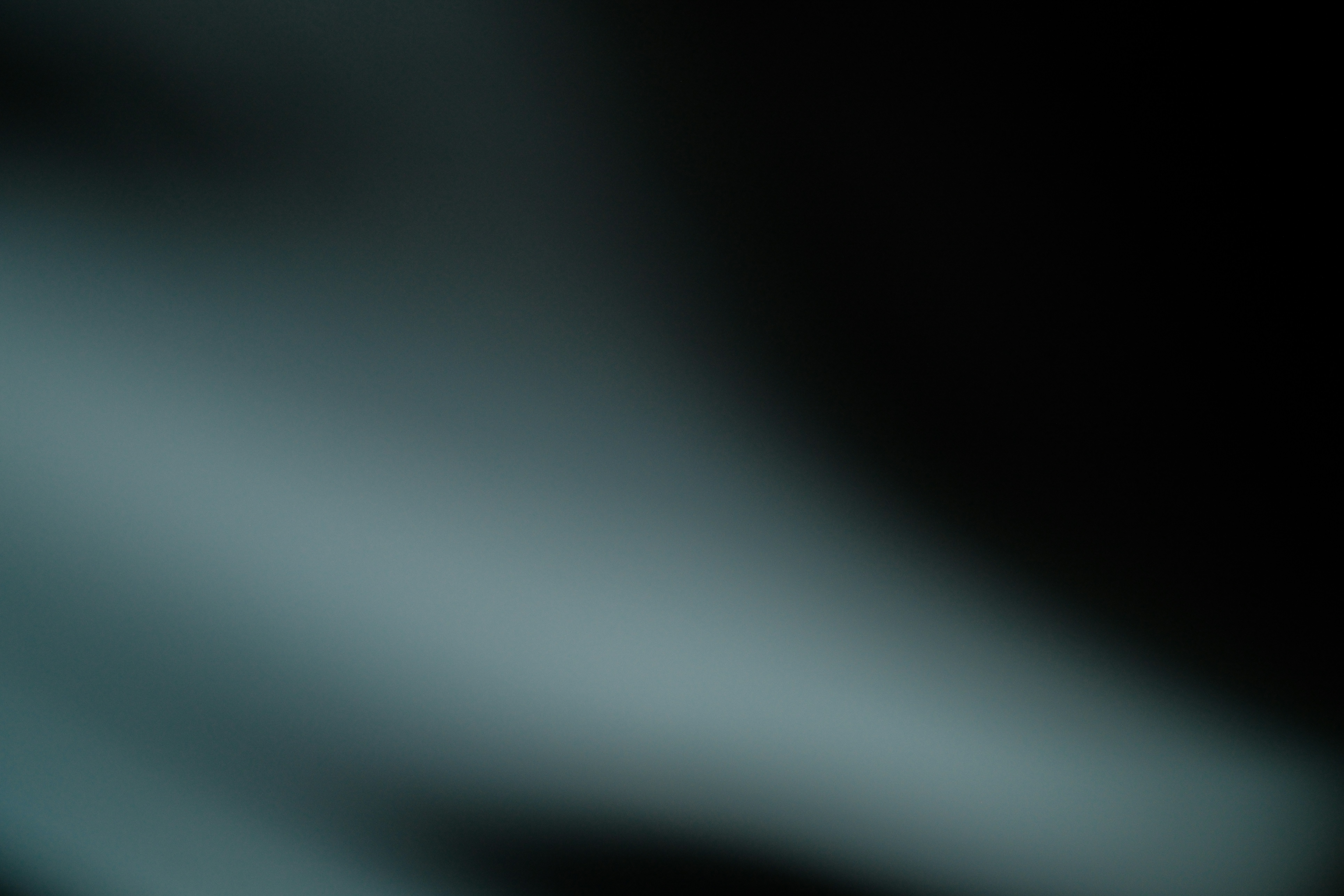 Dark background with abstract light streaks.