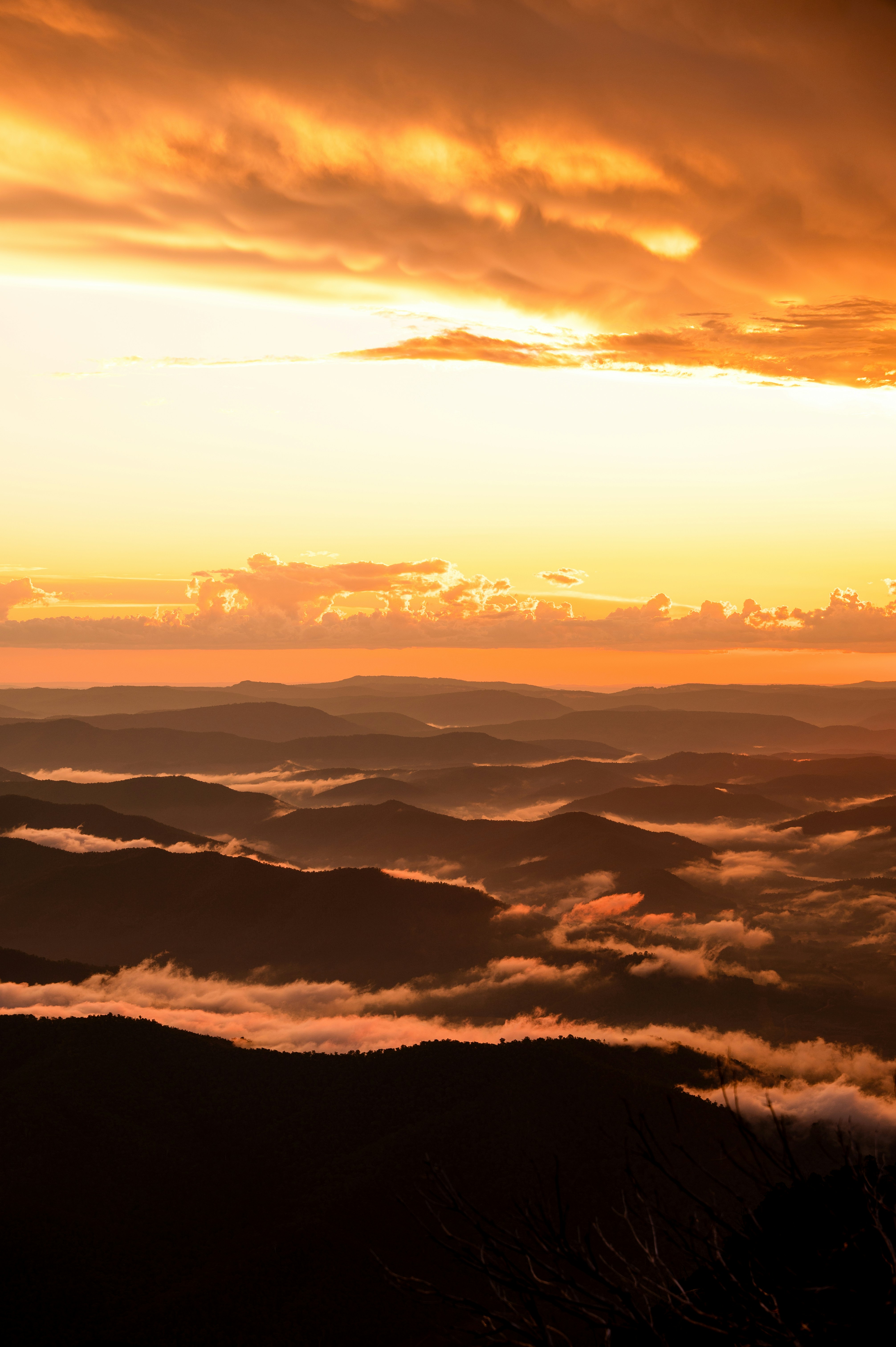 Dramatic sunset over misty mountain ranges