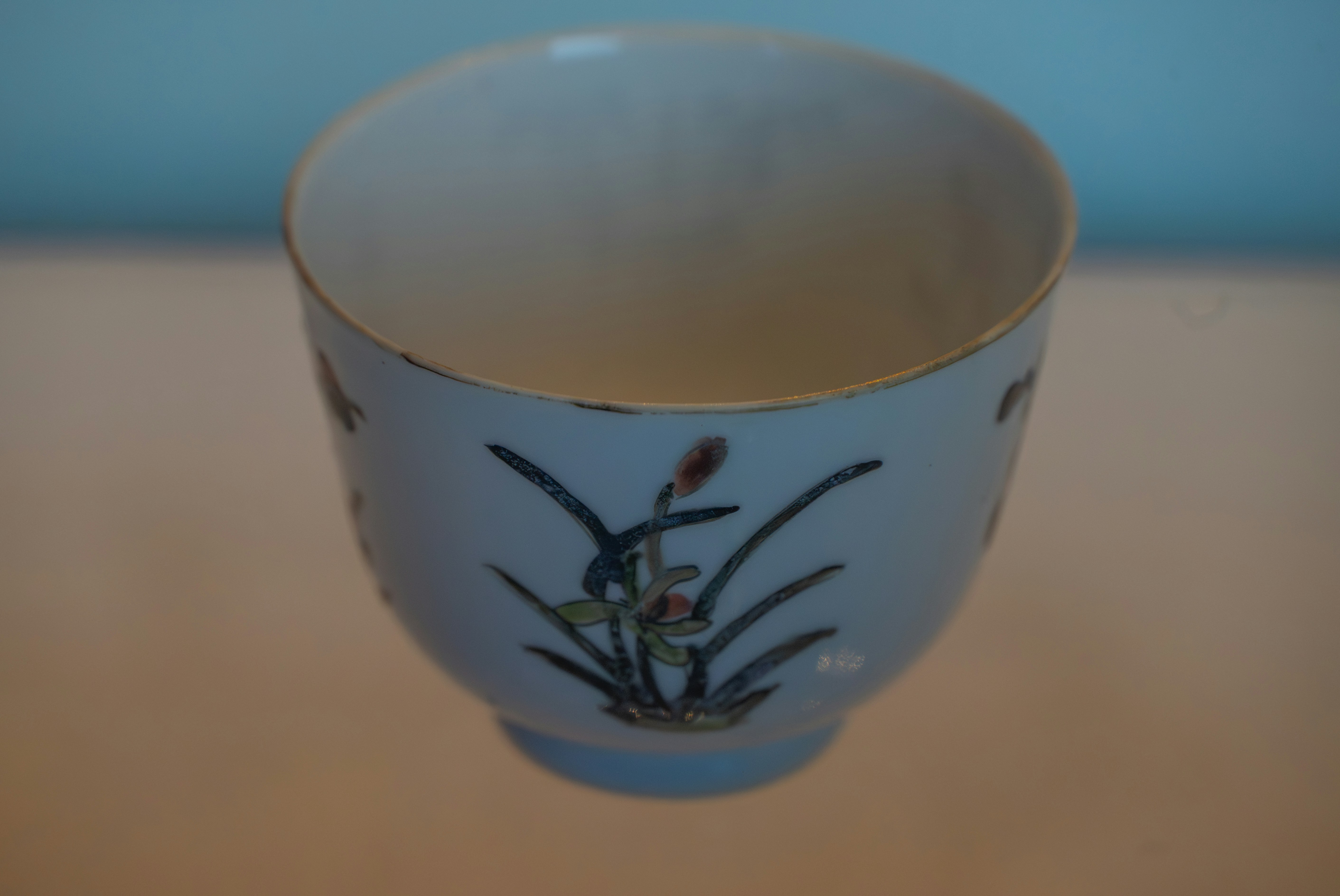 A delicate porcelain teacup with floral designs