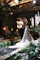Bride and groom walk down a lavishly decorated wedding aisle.