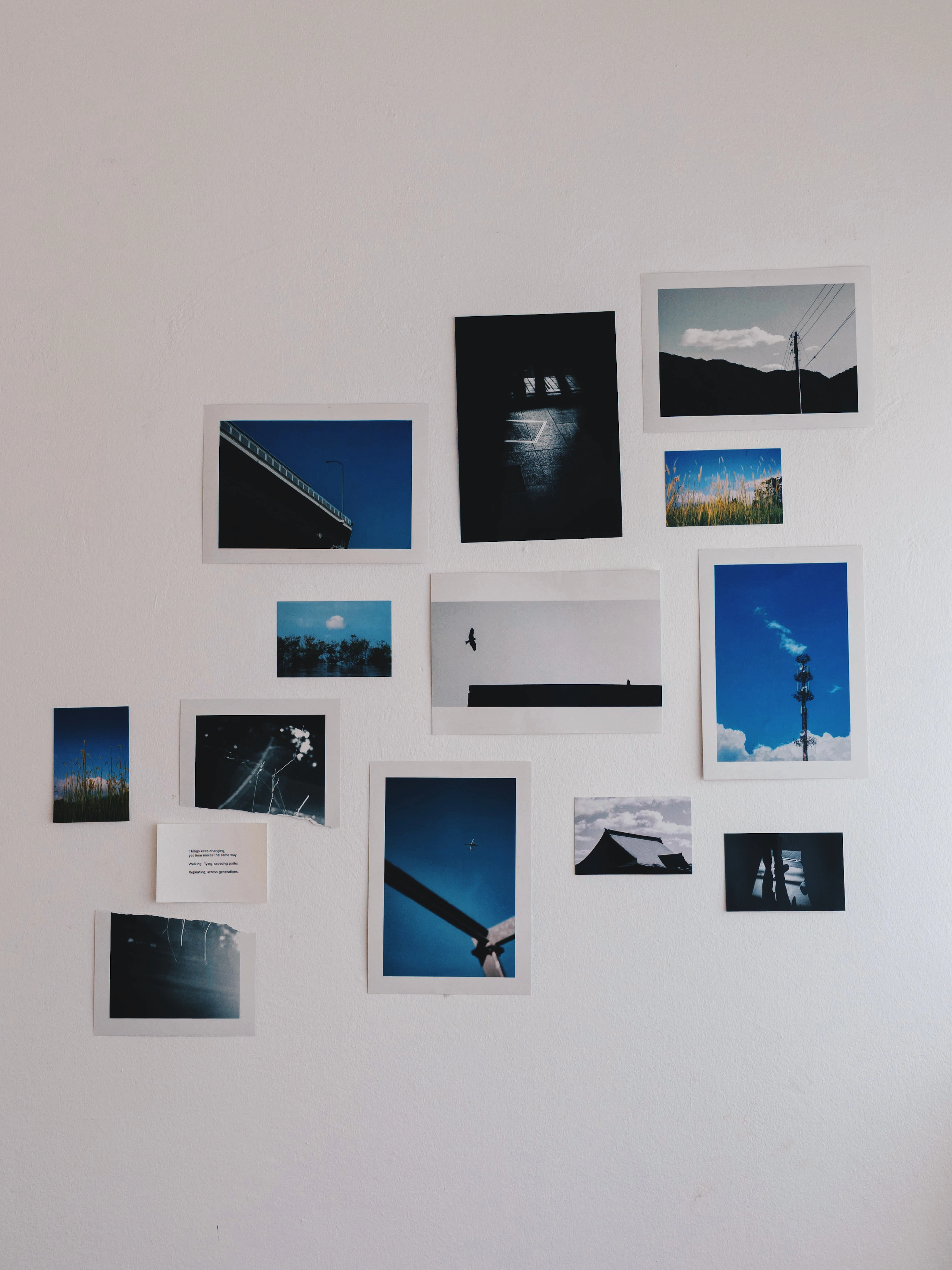 Collection of framed photographs on a white wall