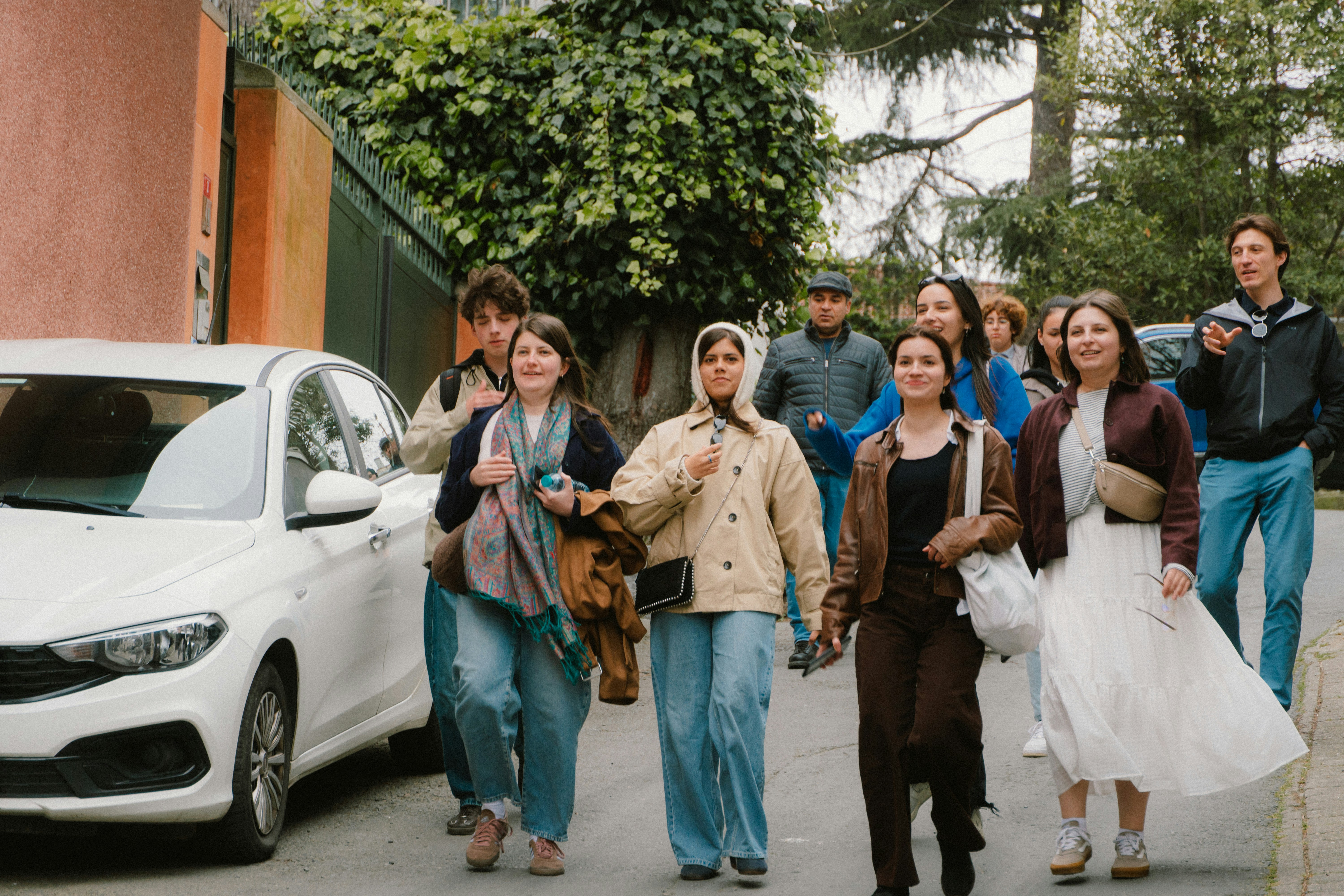 A group of people walking down a street together.