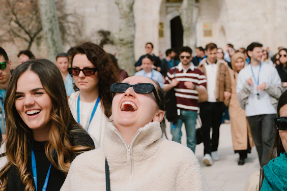 A group of people laughing and enjoying themselves outdoors.