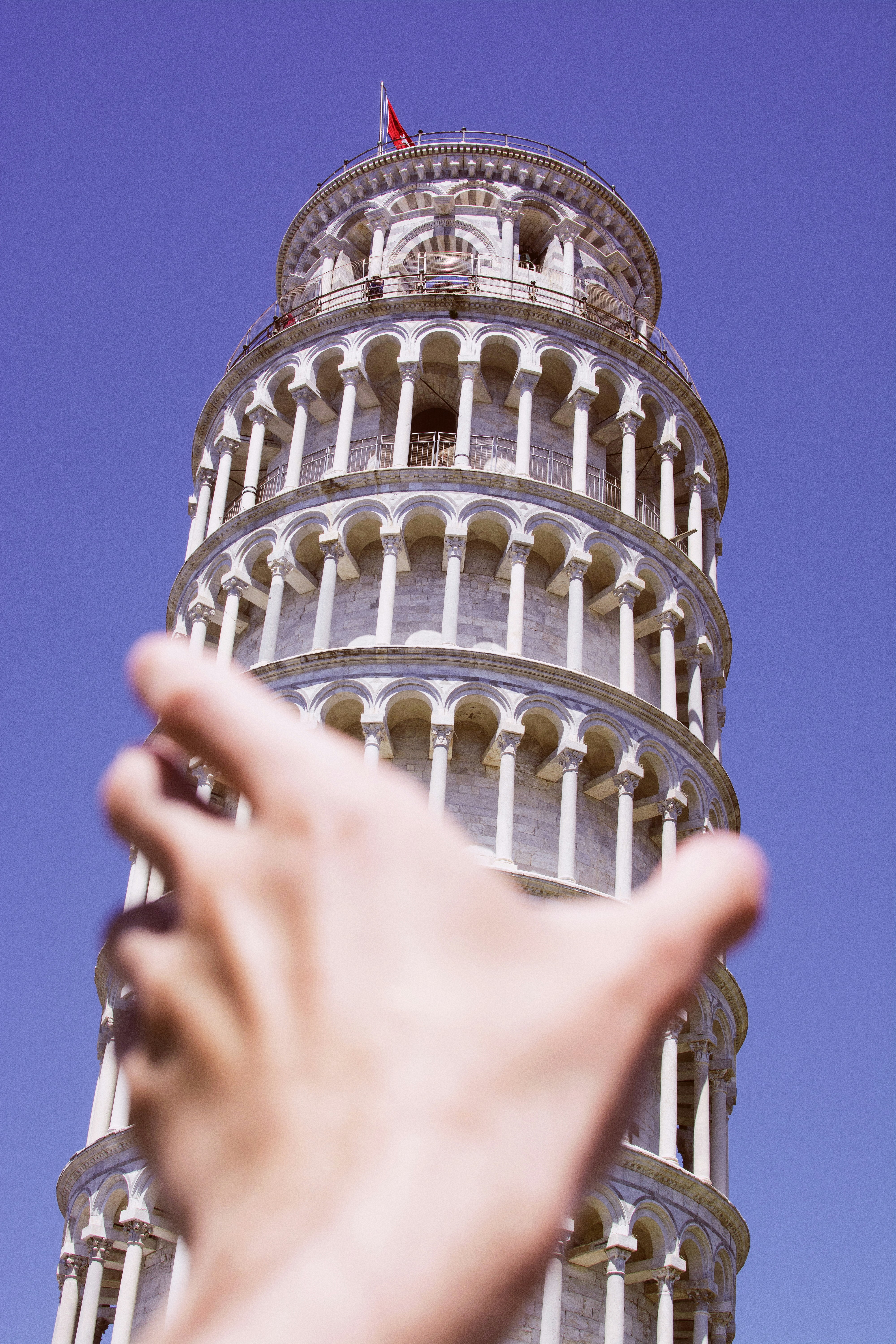 Leaning tower of pisa with outstretched hand