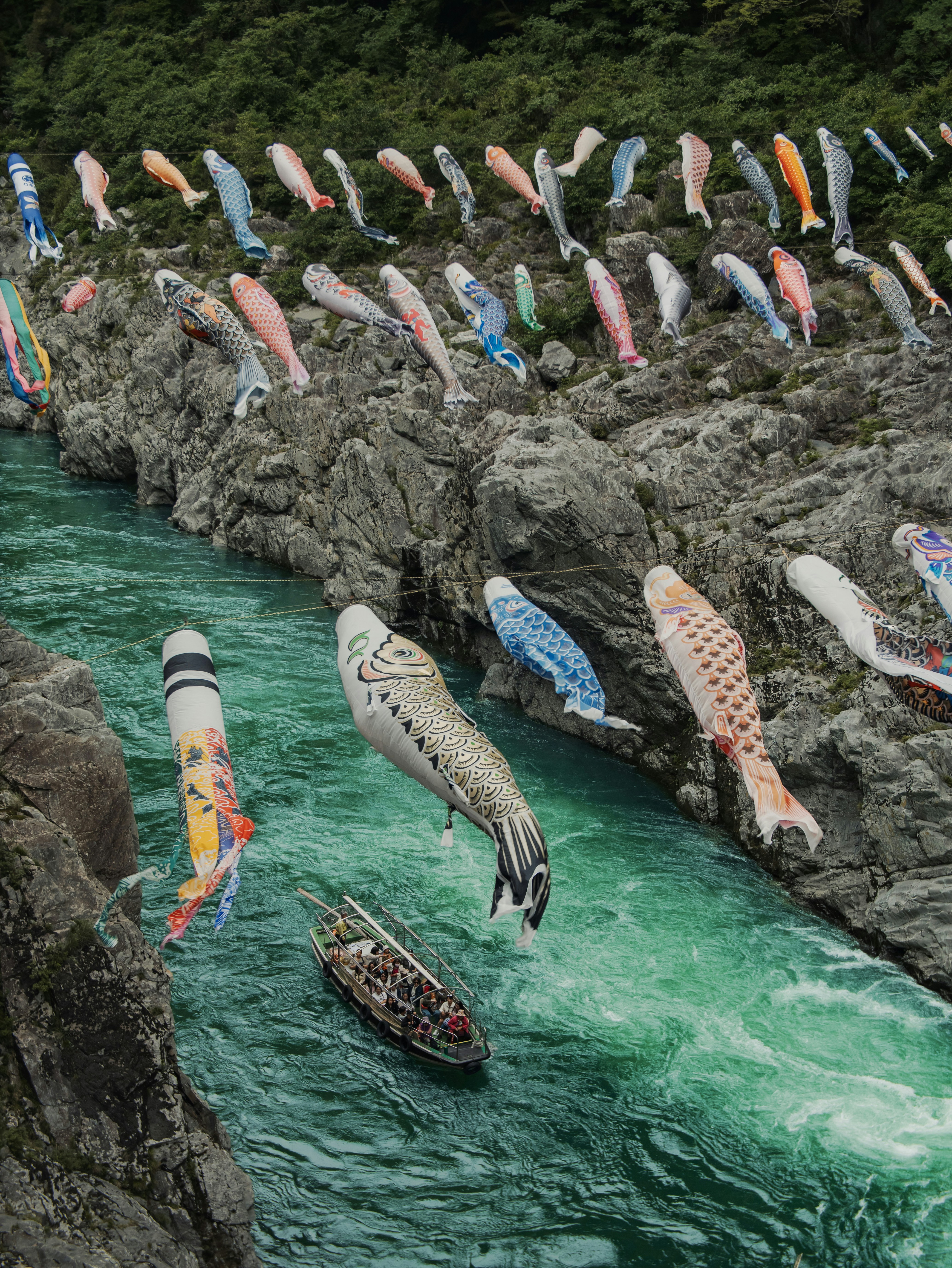 Colorful carp streamers flying over a rushing river