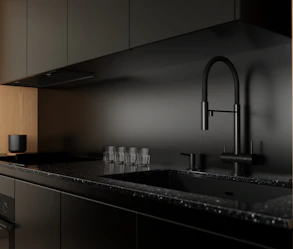 Modern black kitchen counter with sink and faucet