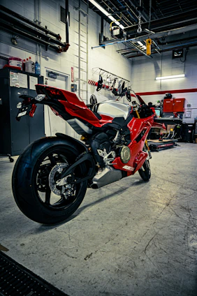 A red sport motorcycle parked in a garage.