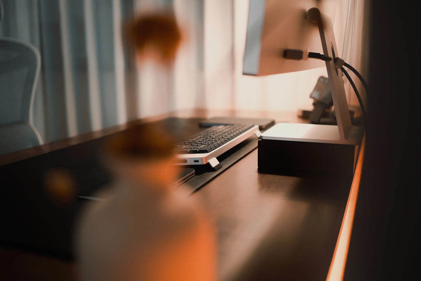 Home office desk with monitor keyboard and organized workspace