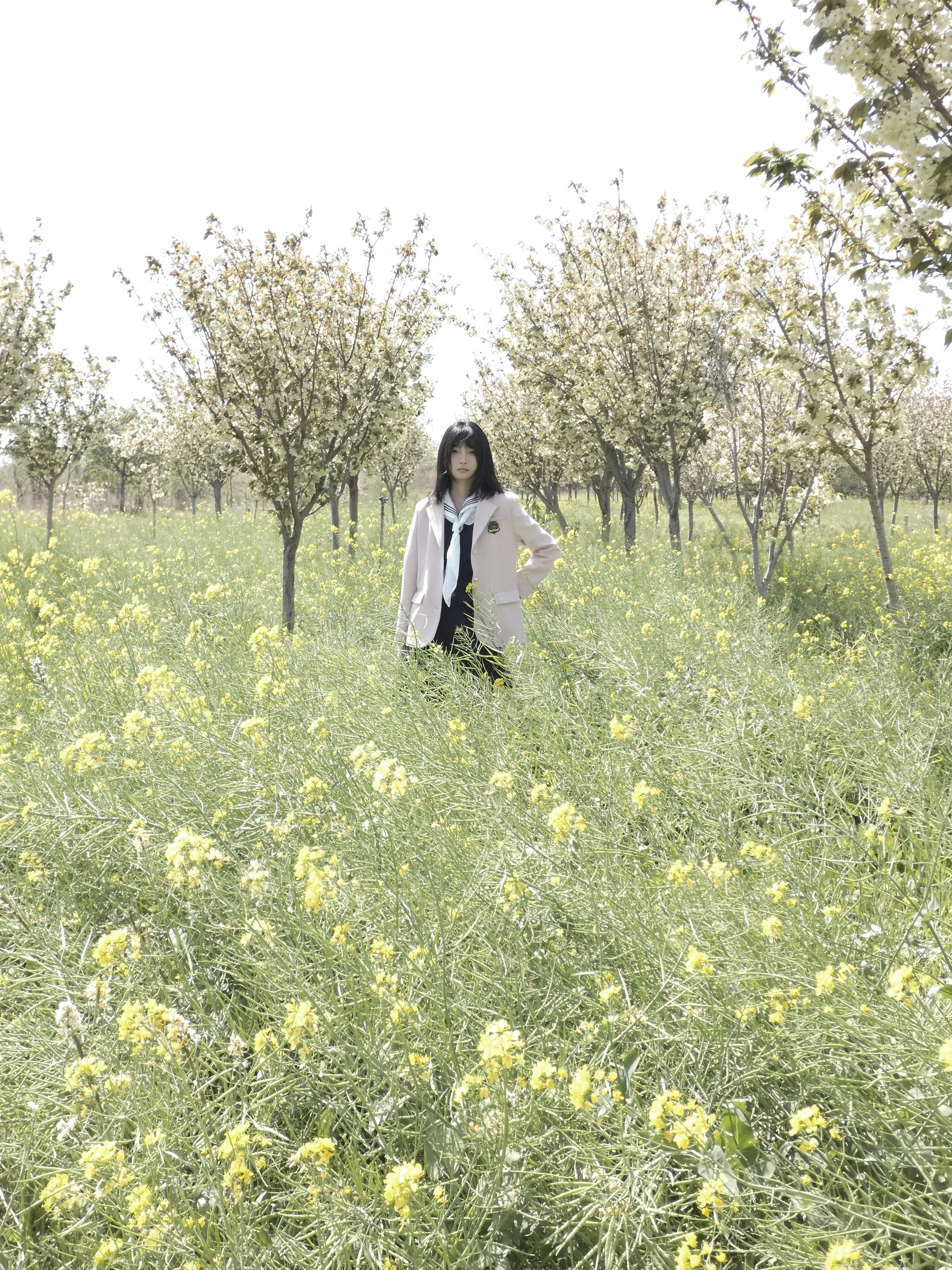 Young woman in a field of yellow flowers