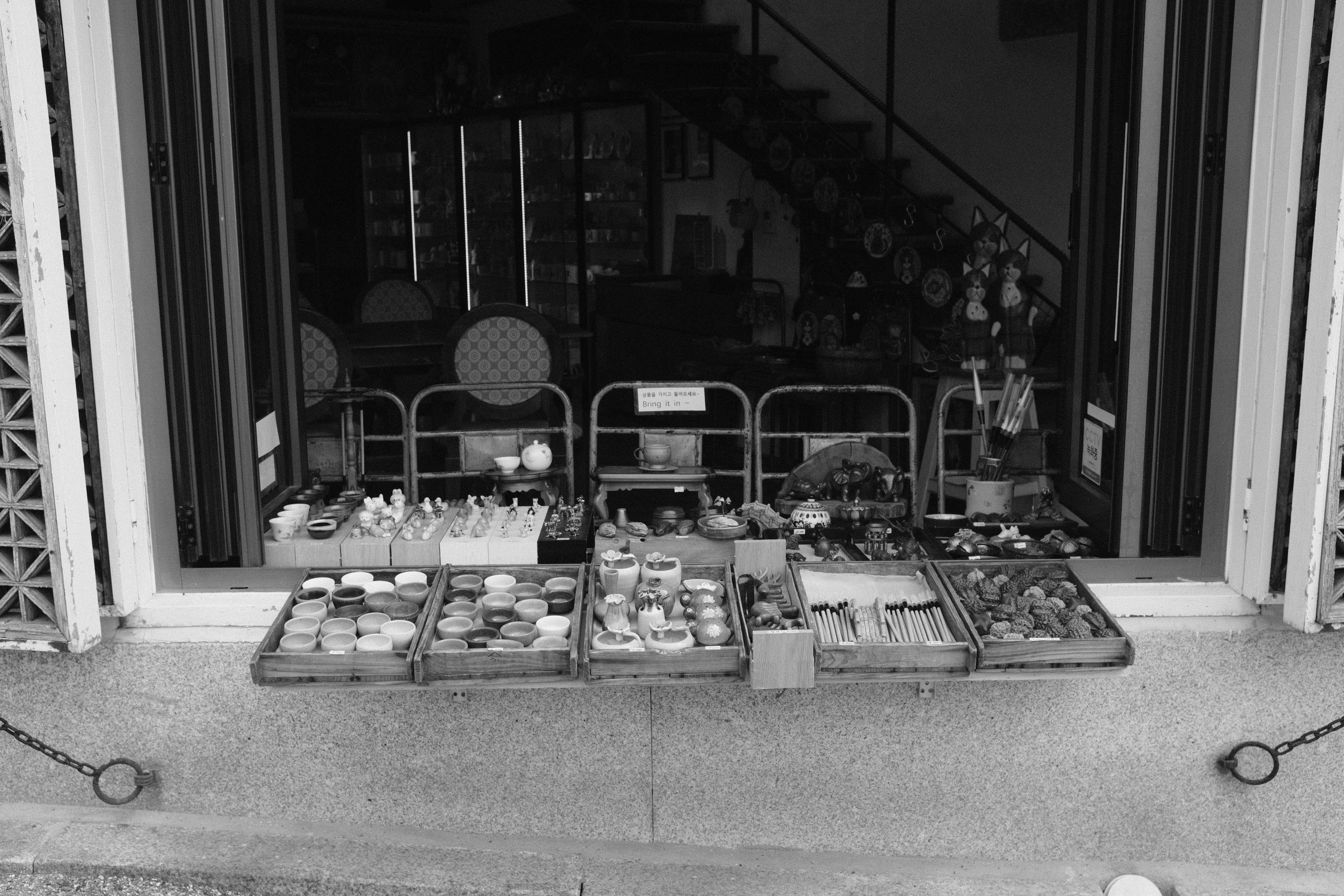 Small shop window display with various items for sale items.