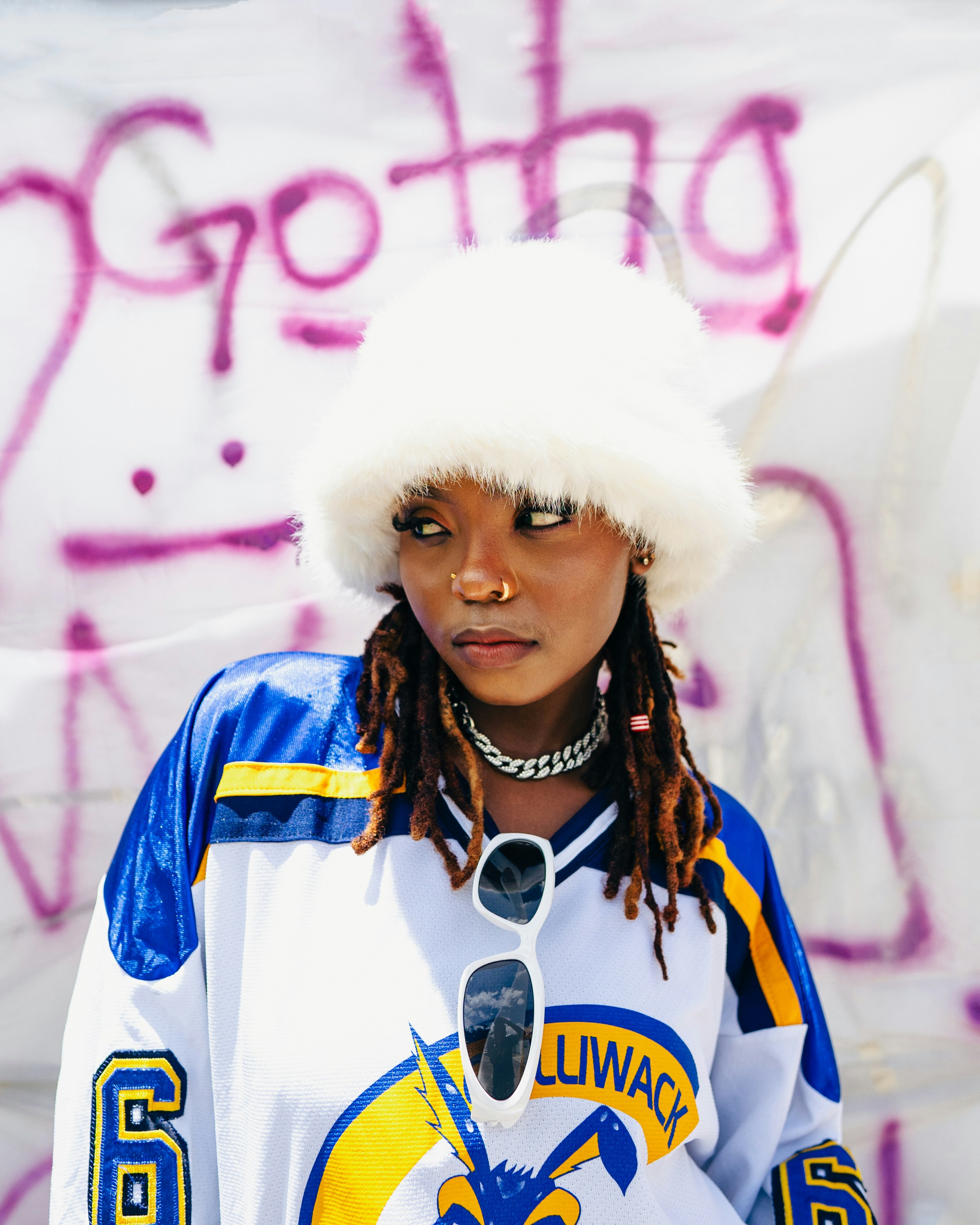 Wanita muda dengan topi halus dan jersey dengan grafiti