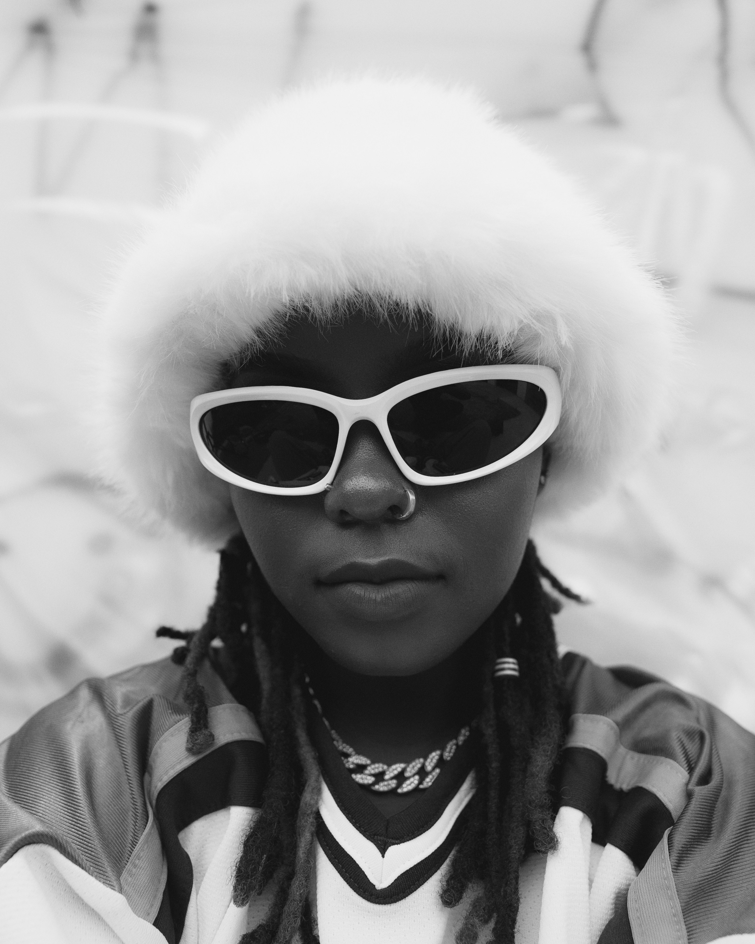 A person wearing a fluffy hat and sunglasses