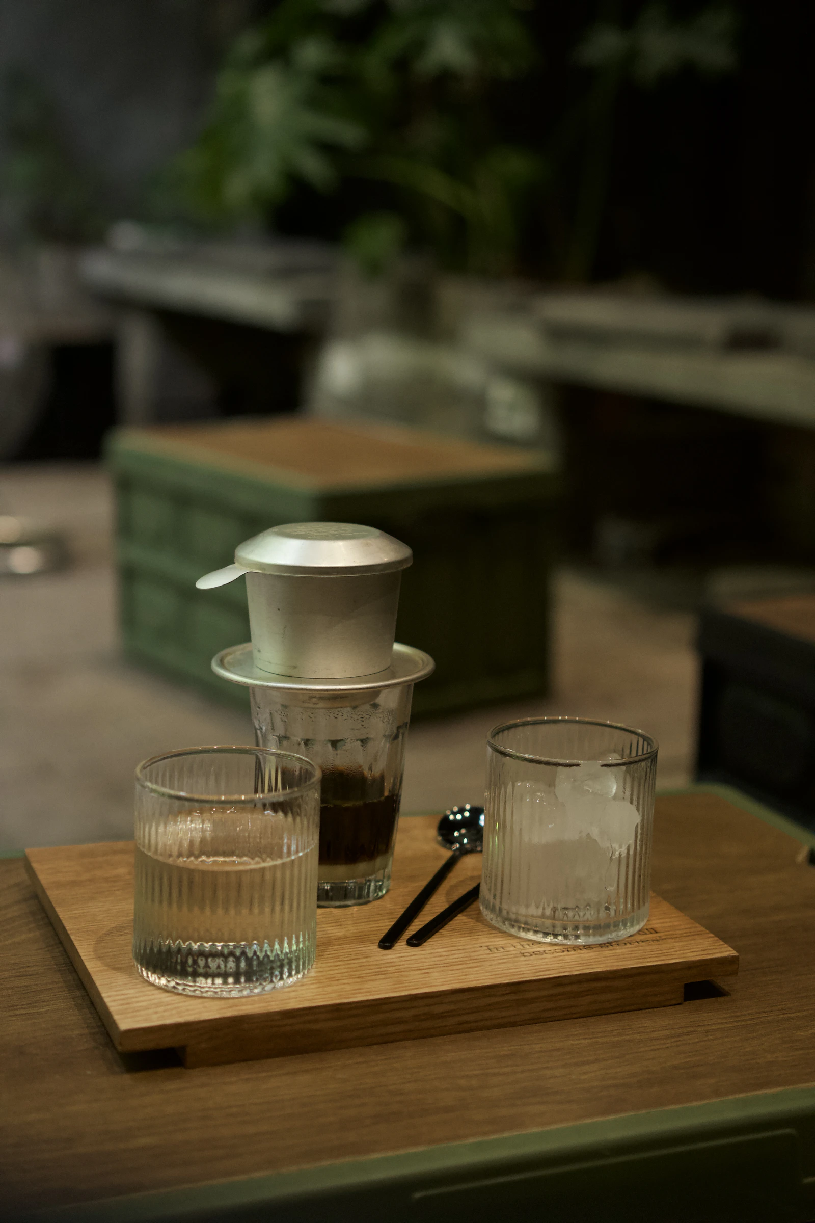 Vietnamese coffee setup with glasses, ice and traditional coffee service