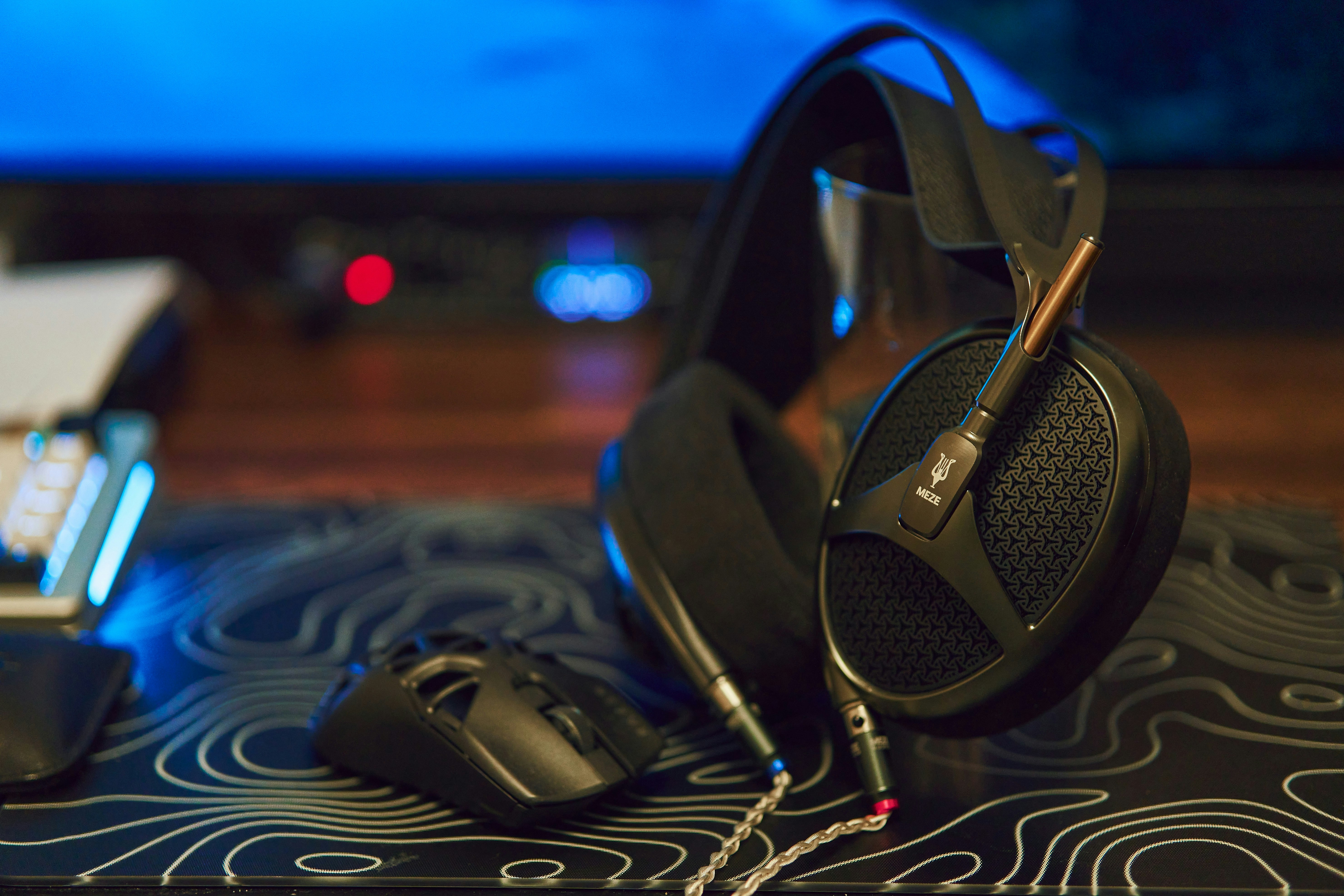 Headphones and gaming mouse on a desk