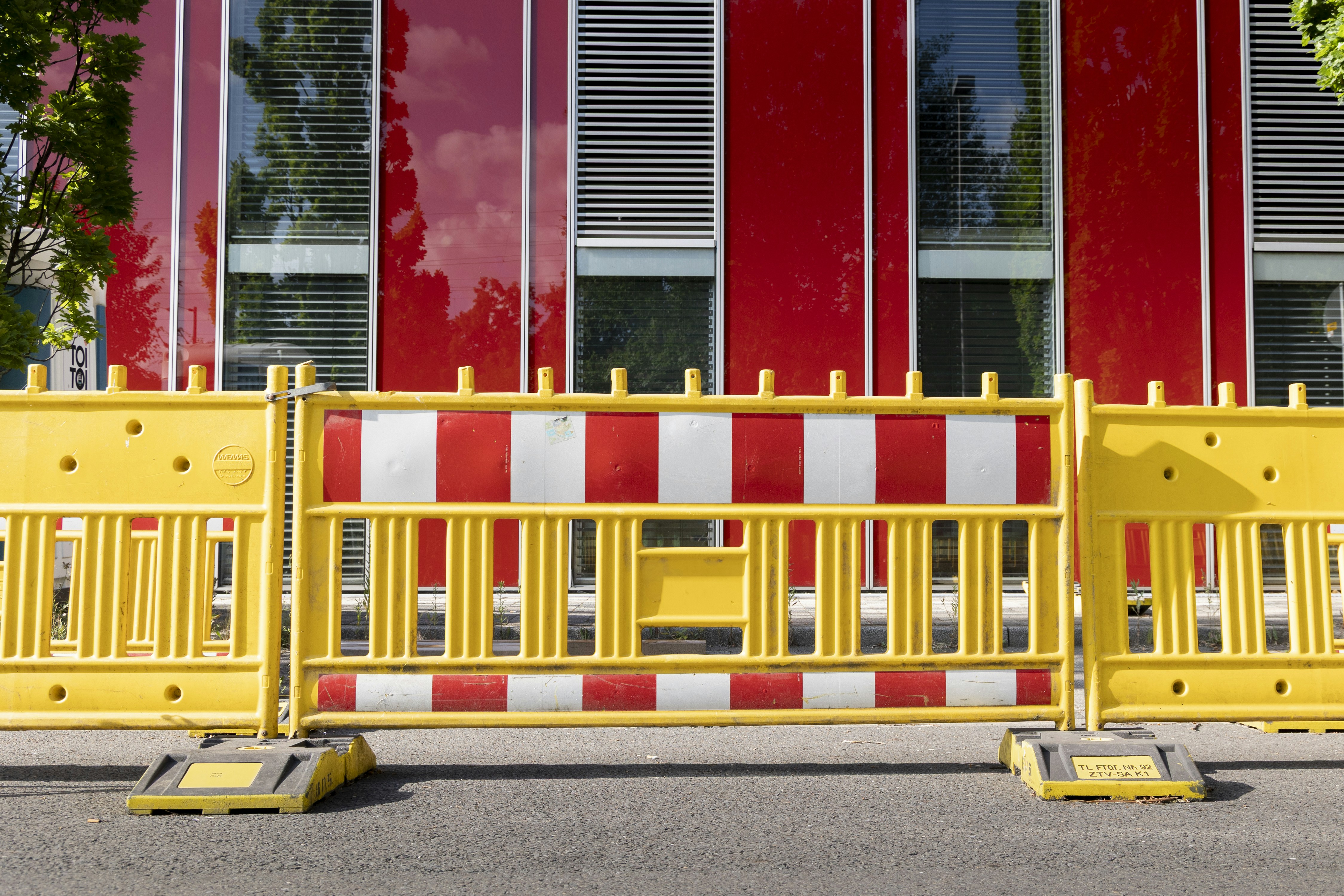 Yellow and red construction barriers in front of building