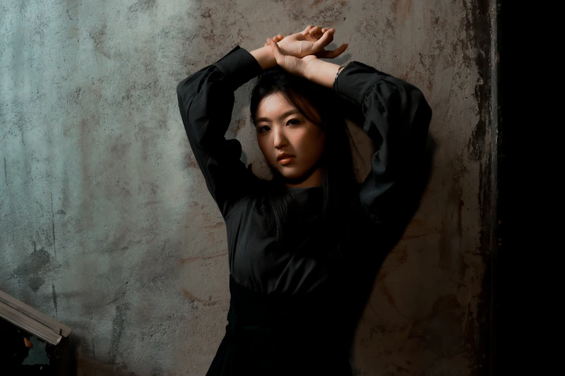 confident woman posing with arms raised