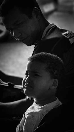 Man looks down at a young child
