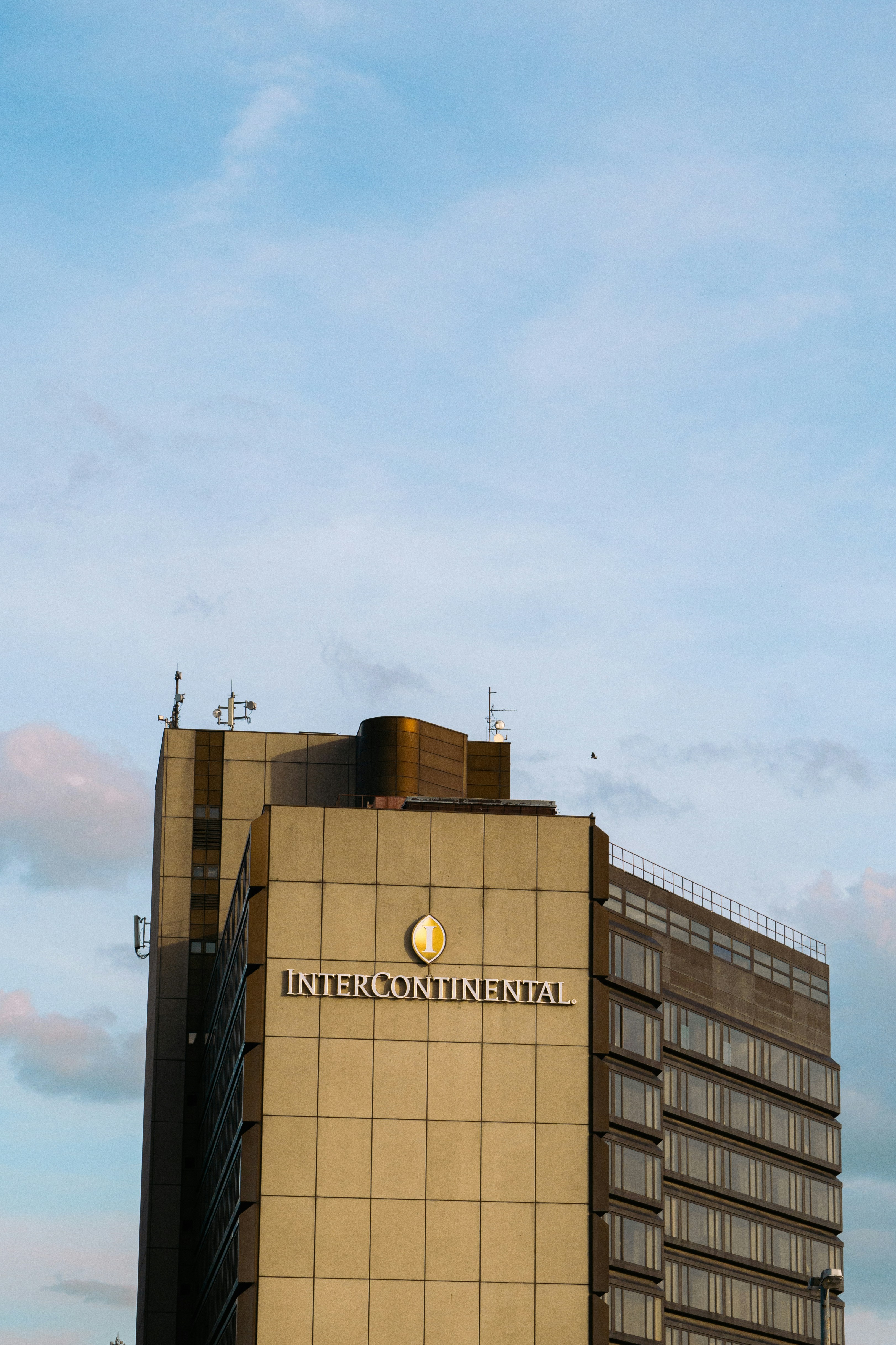 The intercontinental hotel building stands tall against a cloudy sky.