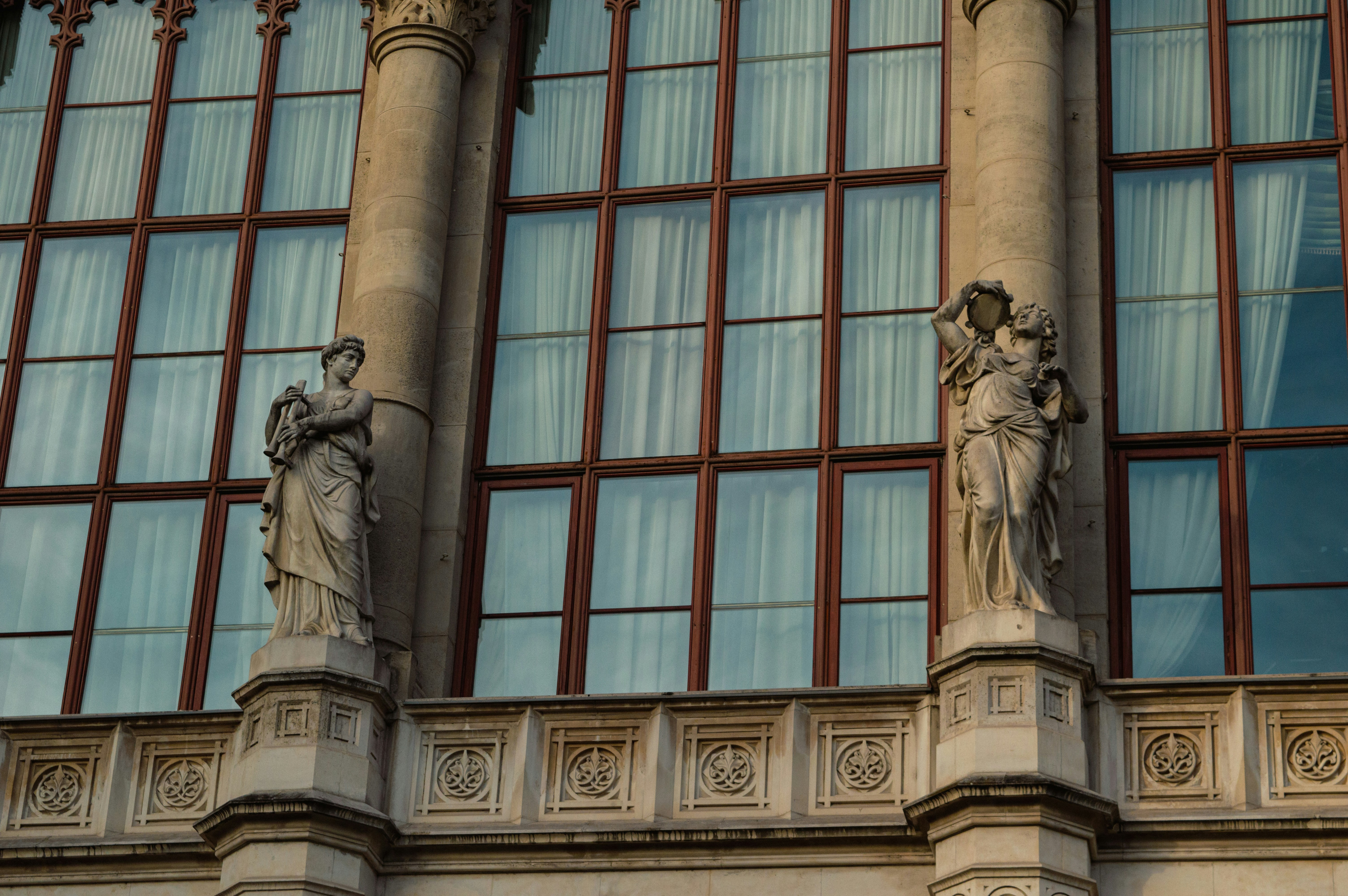 Two stone statues adorn a building facade