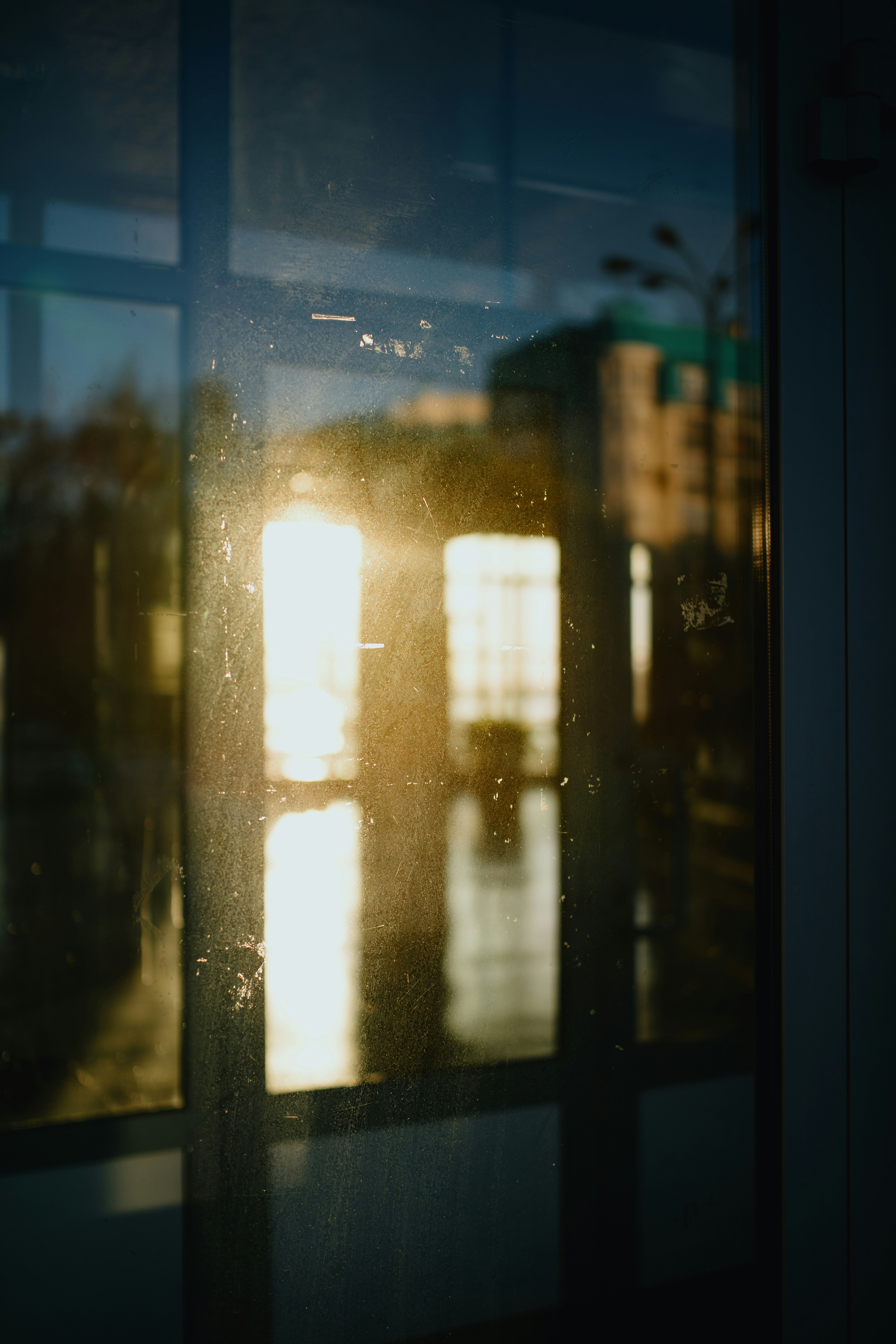 Sunset reflected on a dirty window pane.