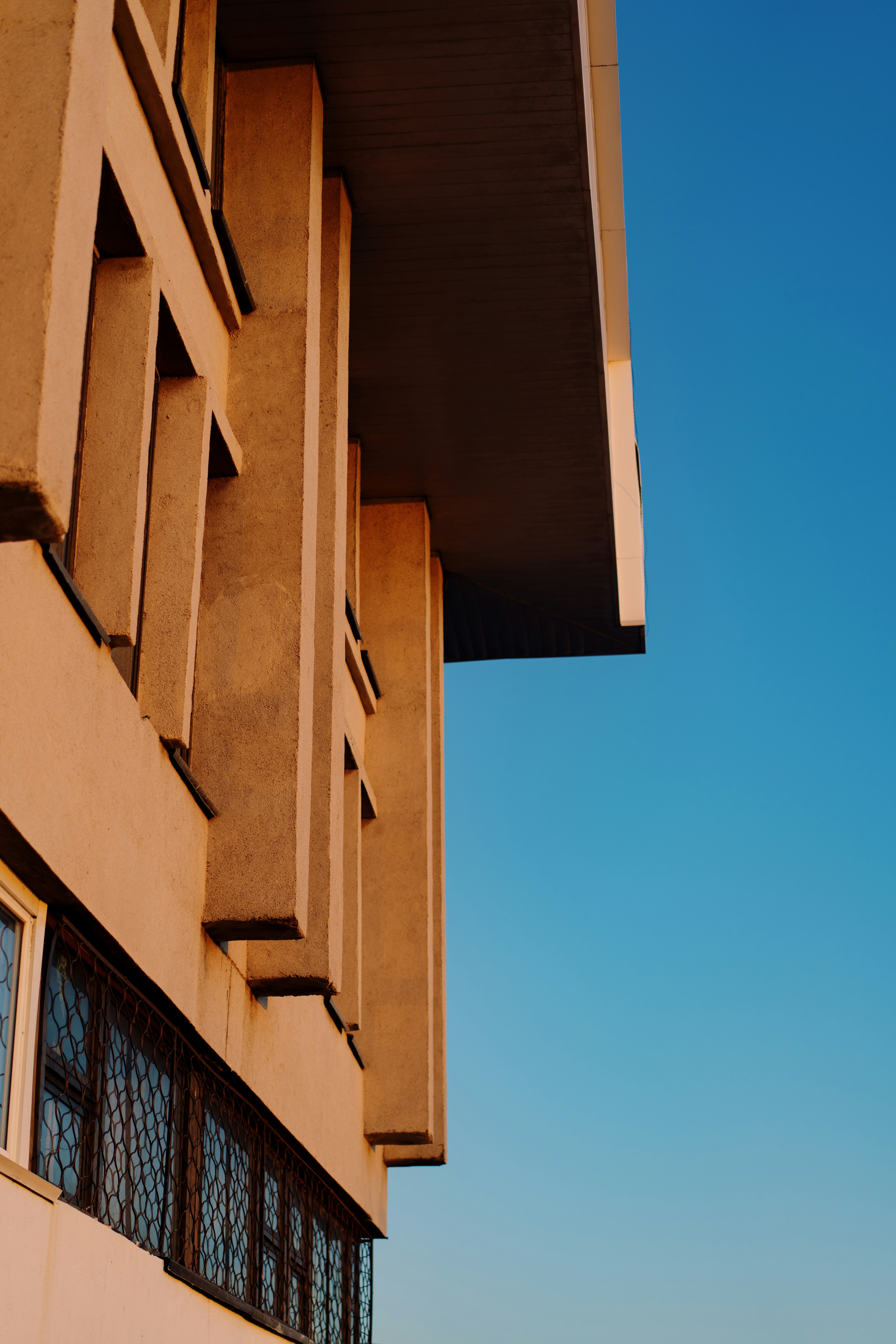 Modern building facade against a clear blue sky