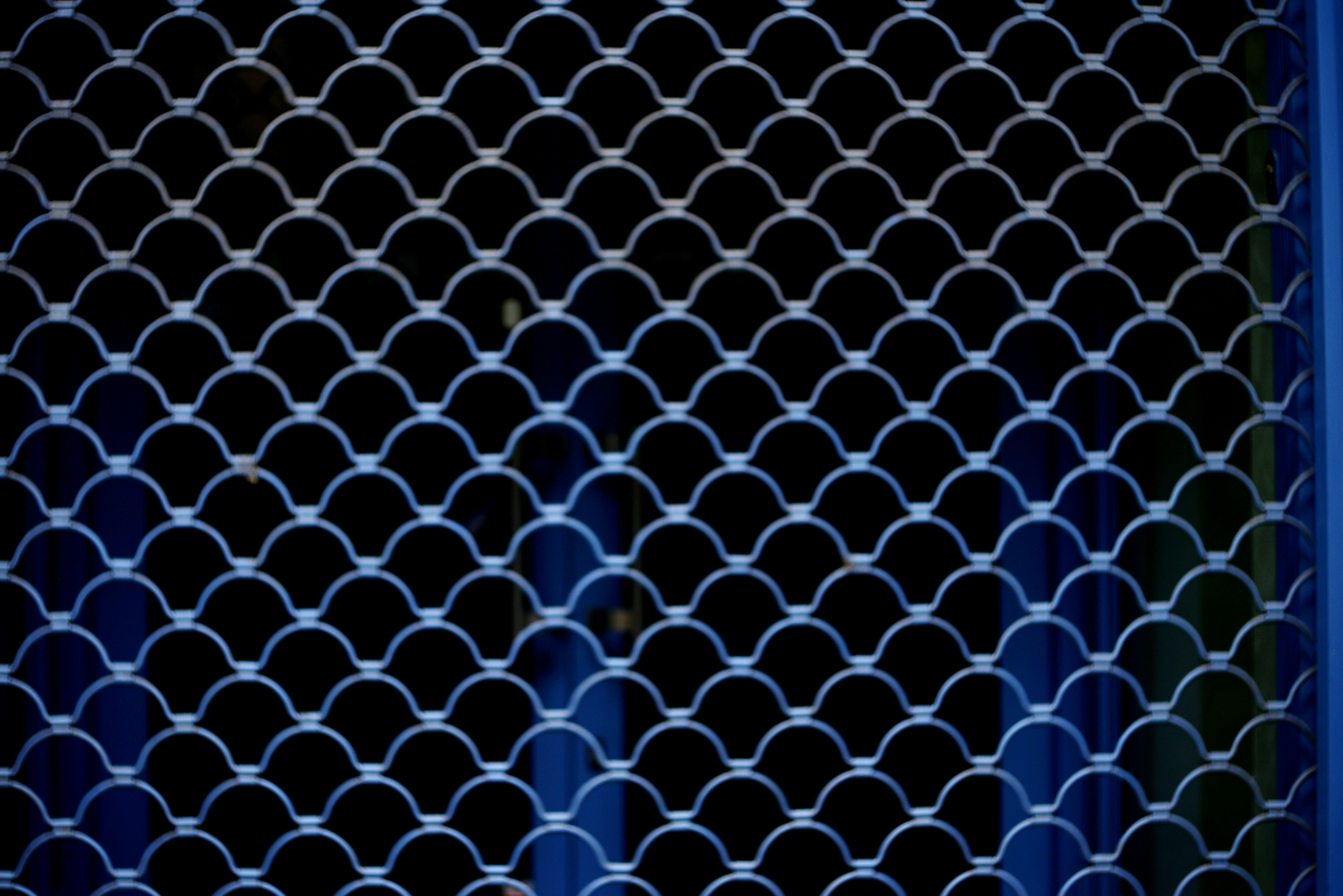 A white metal grate against a dark background.