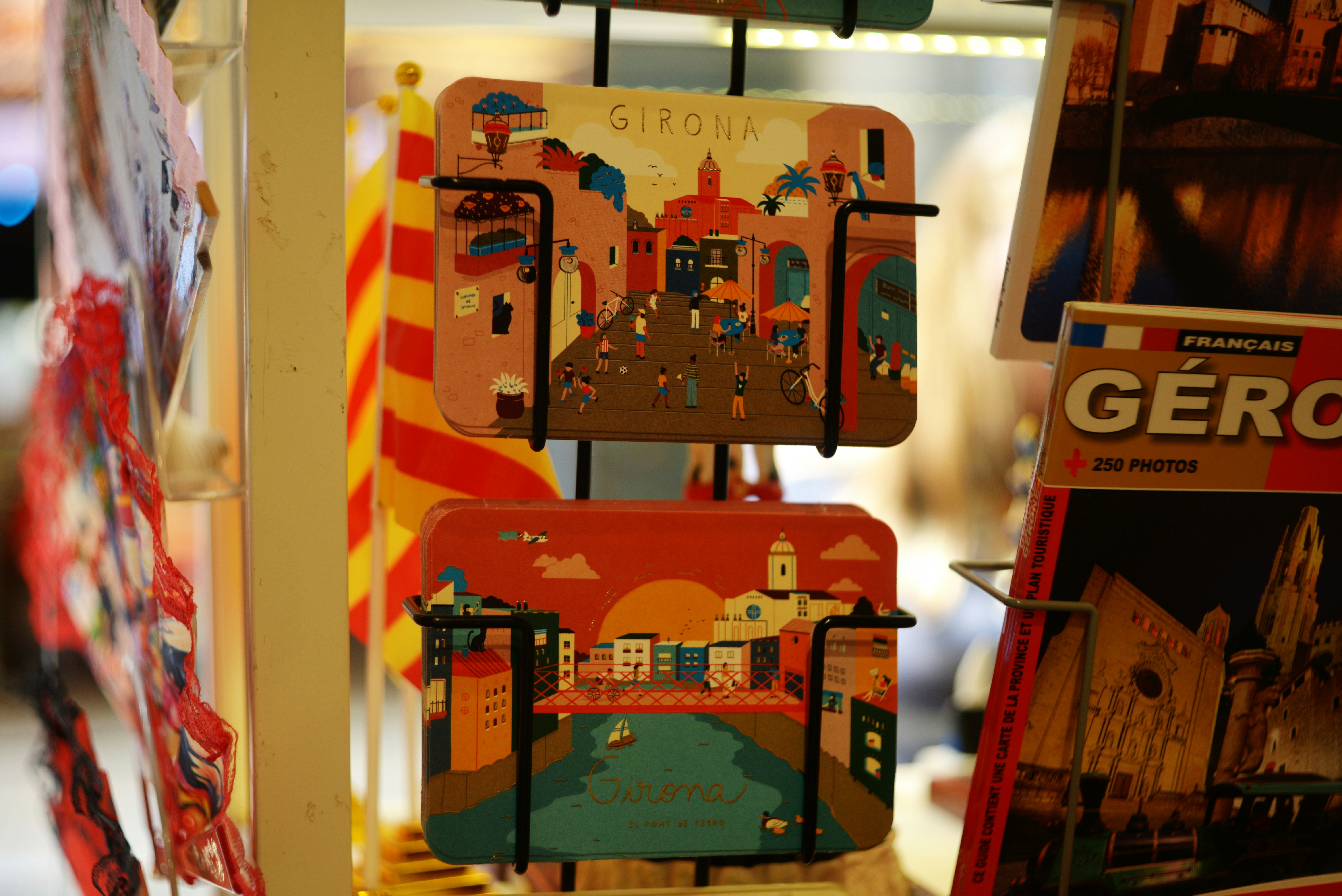 Colorful postcards depicting cityscapes and flags