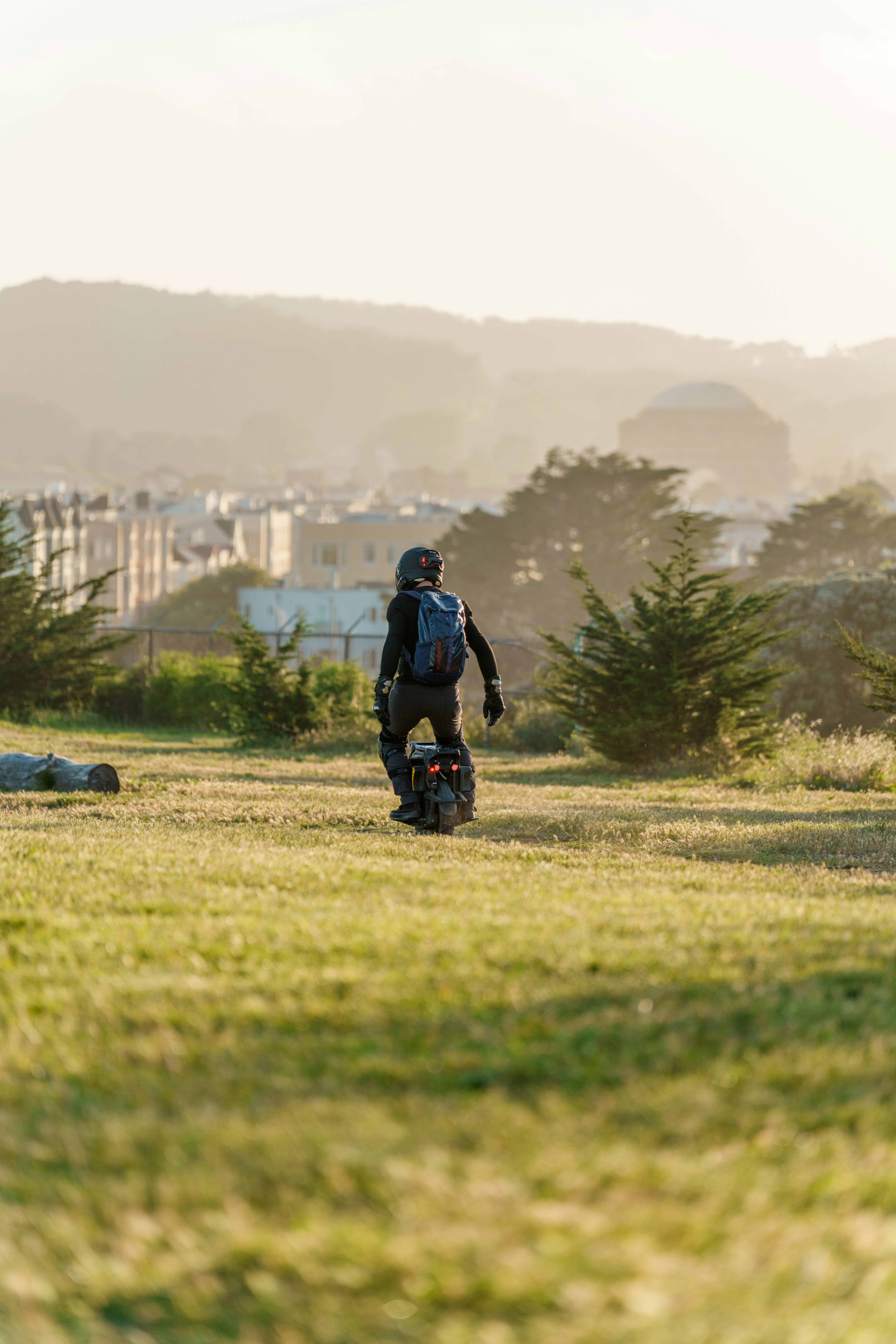 Person riding a one-wheeled electric skateboard outdoors