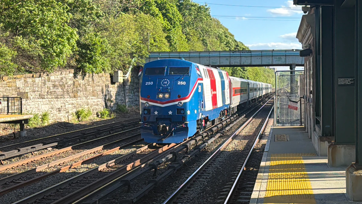 A passenger train waiting alongside a platform at an American station