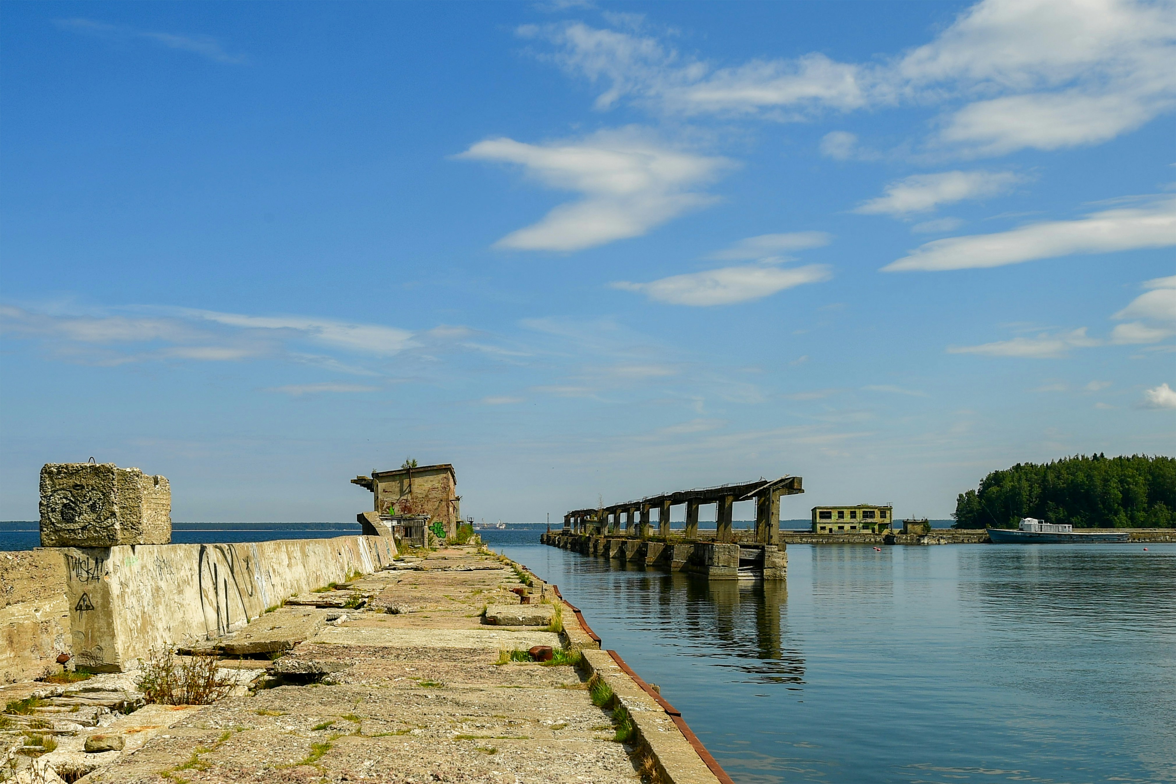 Ruined concrete structures on a calm blue sea