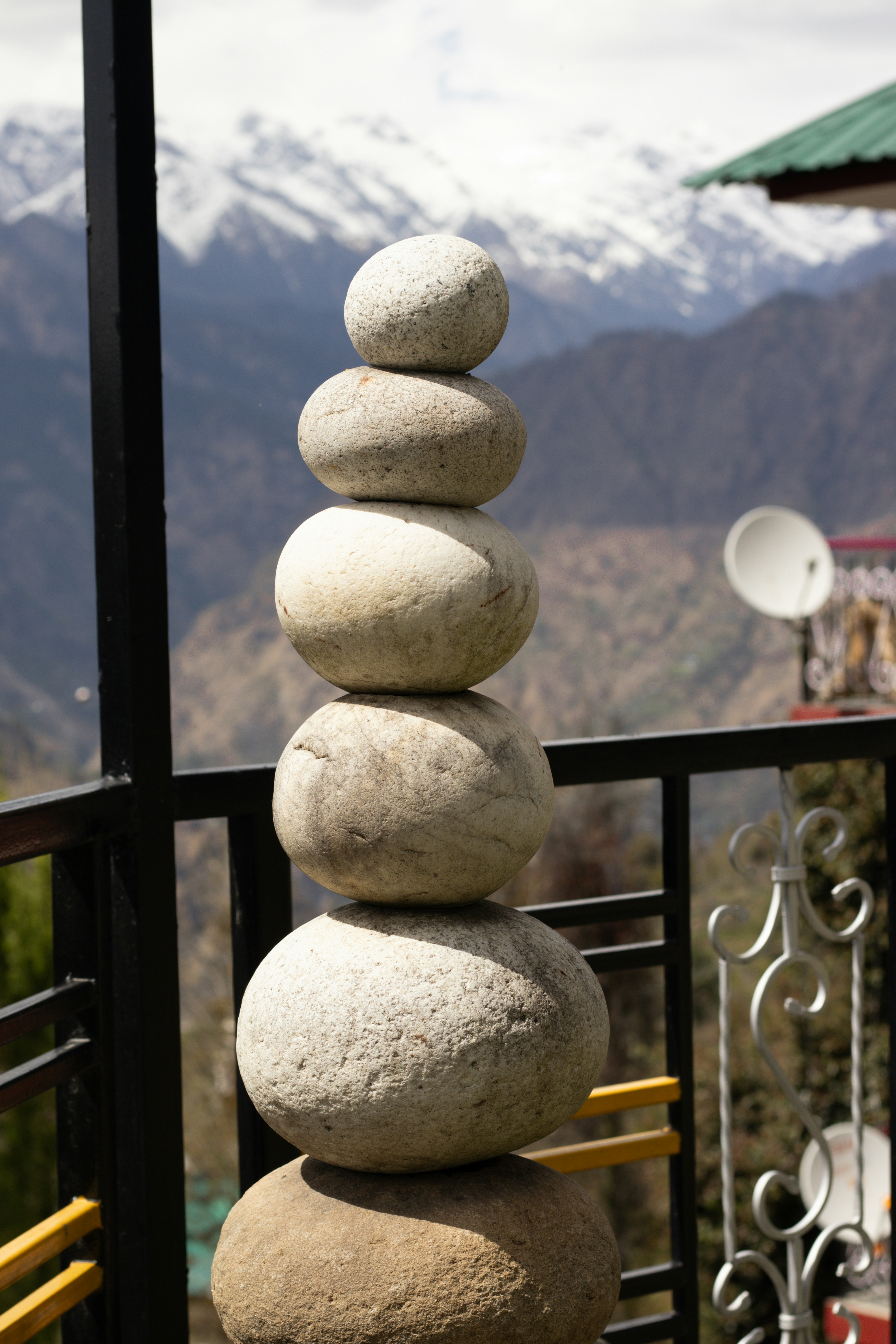 Pila di pietre equilibrate con montagne innevate dietro