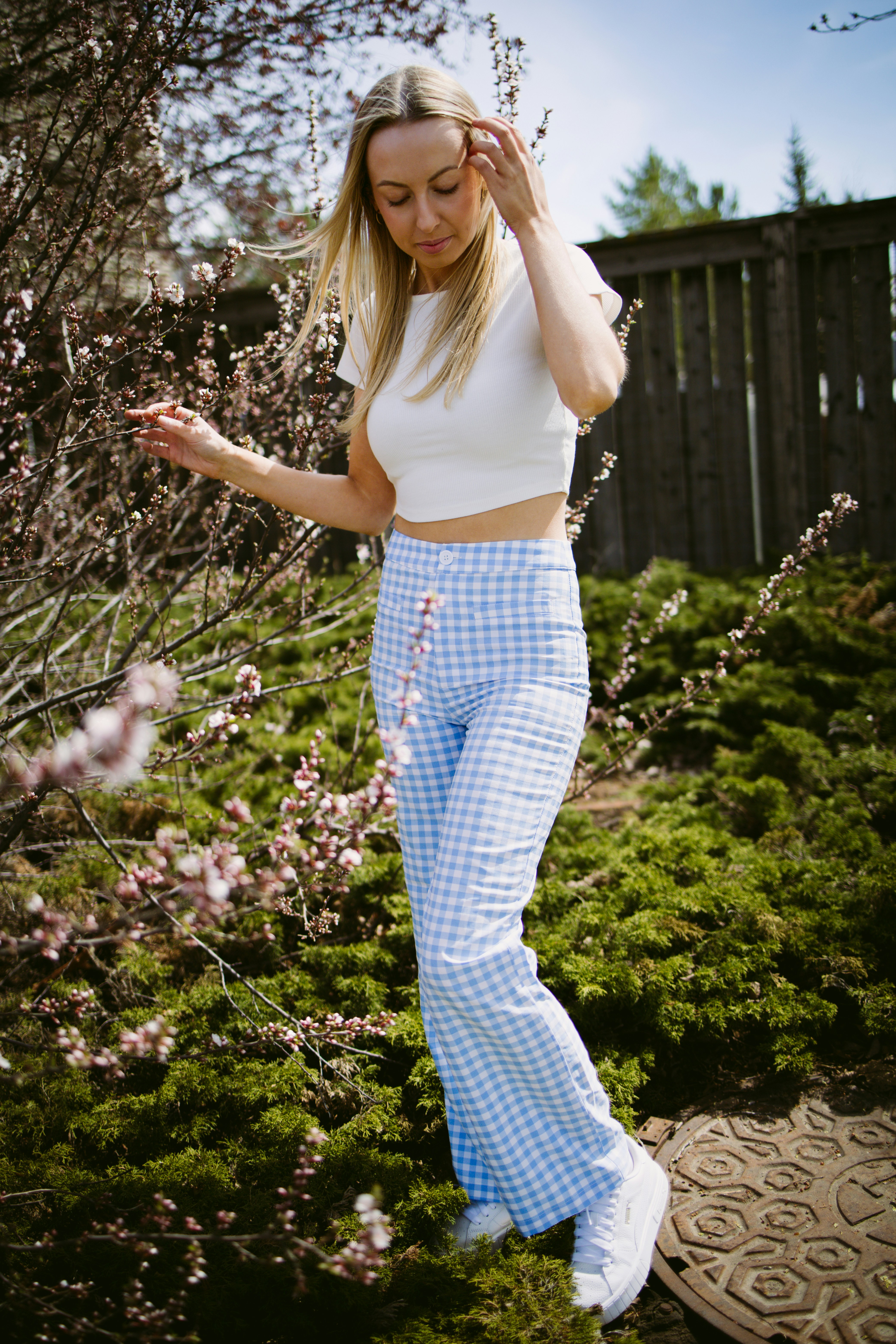 Woman in white top and blue checkered pants