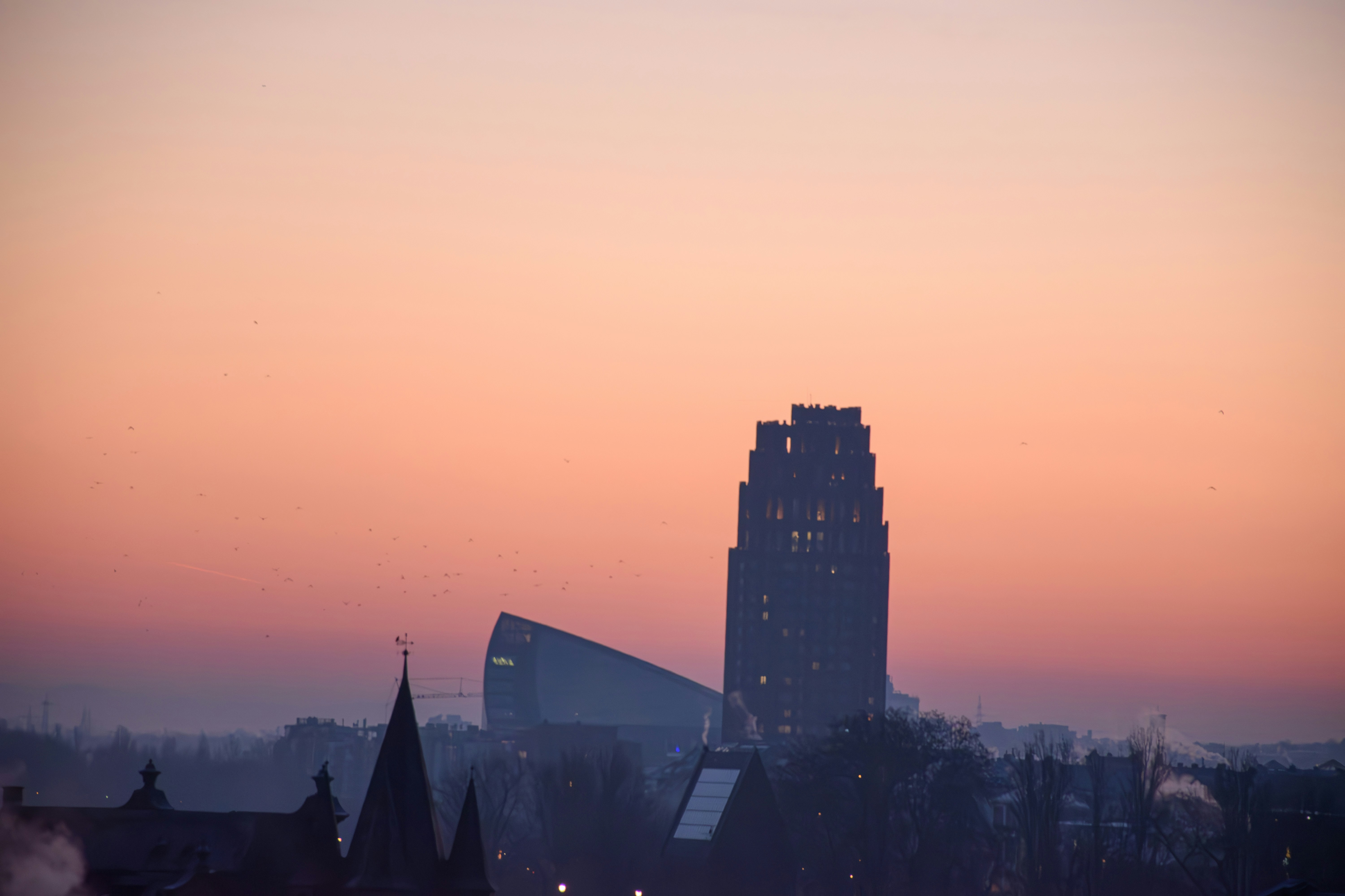 City skyline with modern skyscraper at sunset