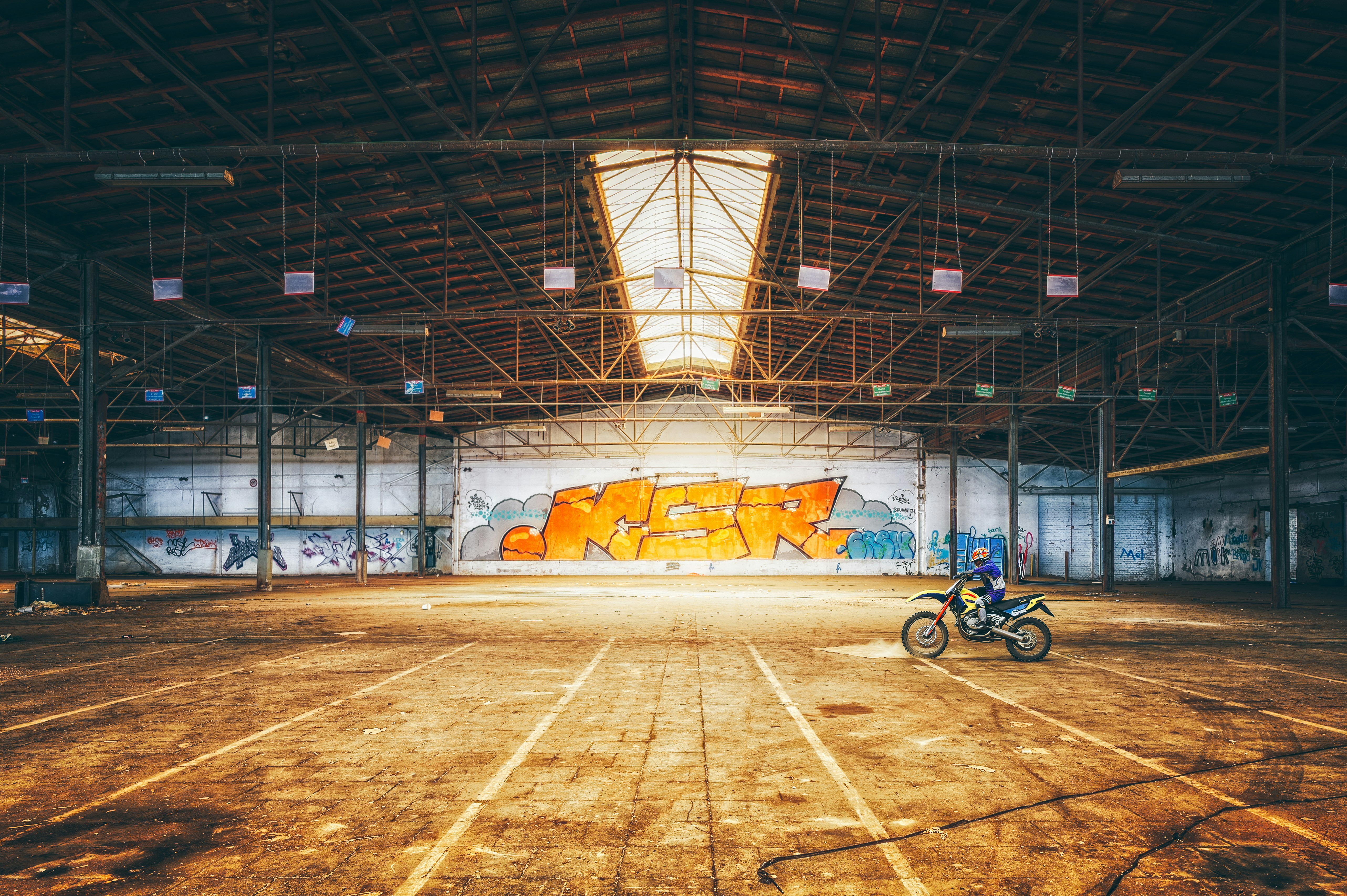 Motorcyclist in an abandoned warehouse with graffiti