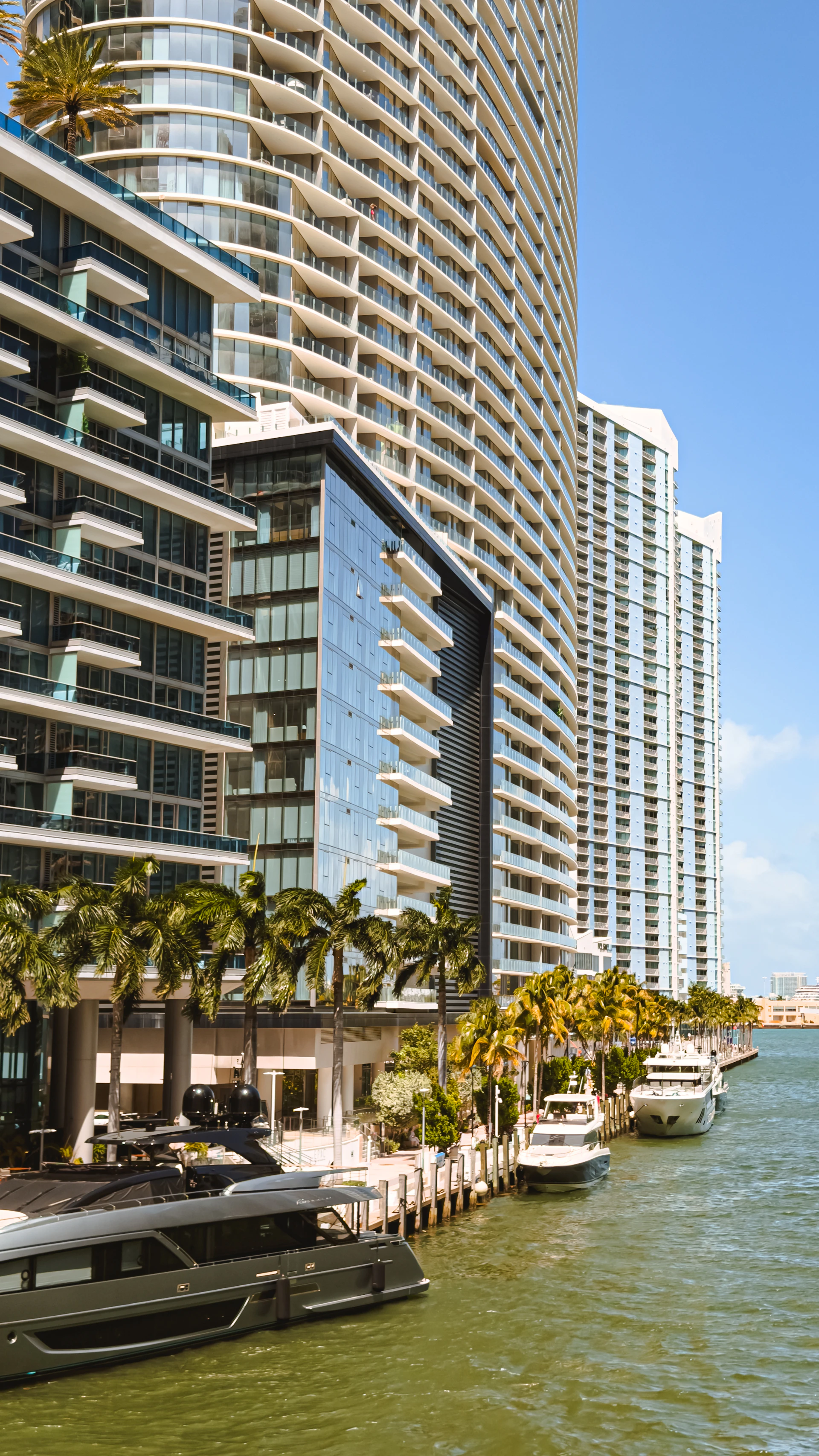 Modern buildings and yachts docked along a waterway