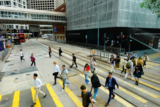 People crossing a busy city street at a crosswalk