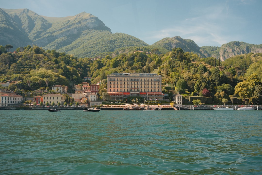 Grand hotel on a lake with mountains behind